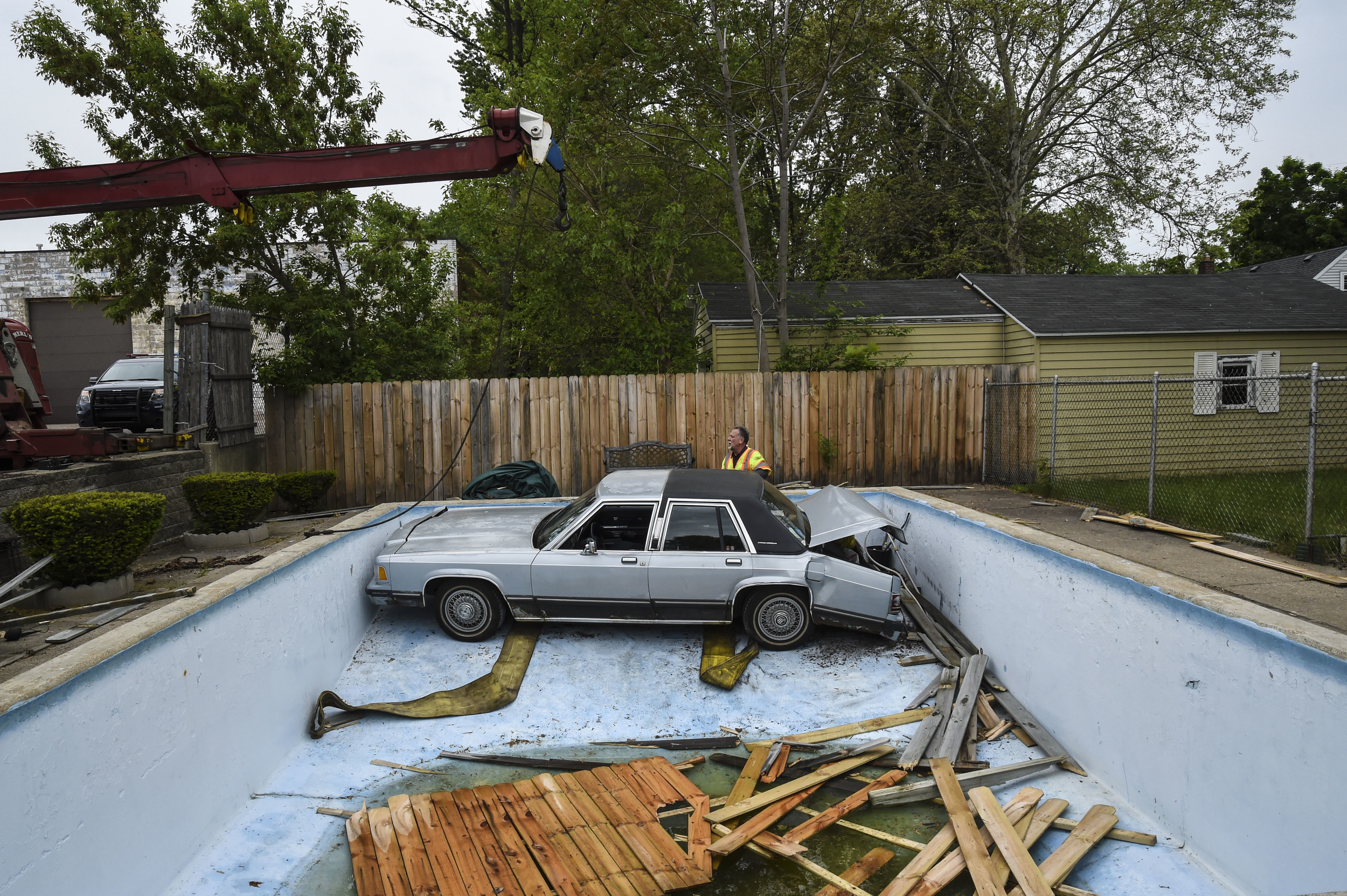  An elderly woman accidentally drove her vehicle through a fence and into a Wyoming resident's pool while at the CVS pharmacy window Sunday, May 24, 2015, off 28th St. in Wyoming, MI. &nbsp; 