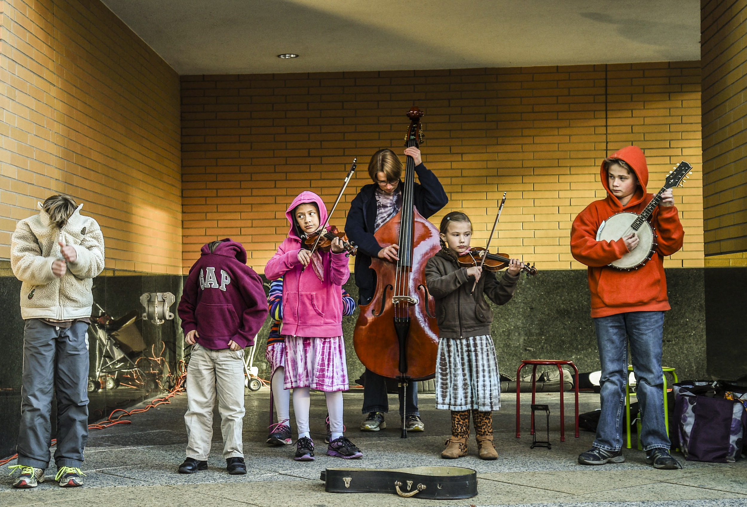  A group of children ranging in age from 5-years-old to 15-years-old, play musical instruments outside the DeVos Place, Thursday, Oct. 1, 2015, in Grand Rapids, Mich.&nbsp; 