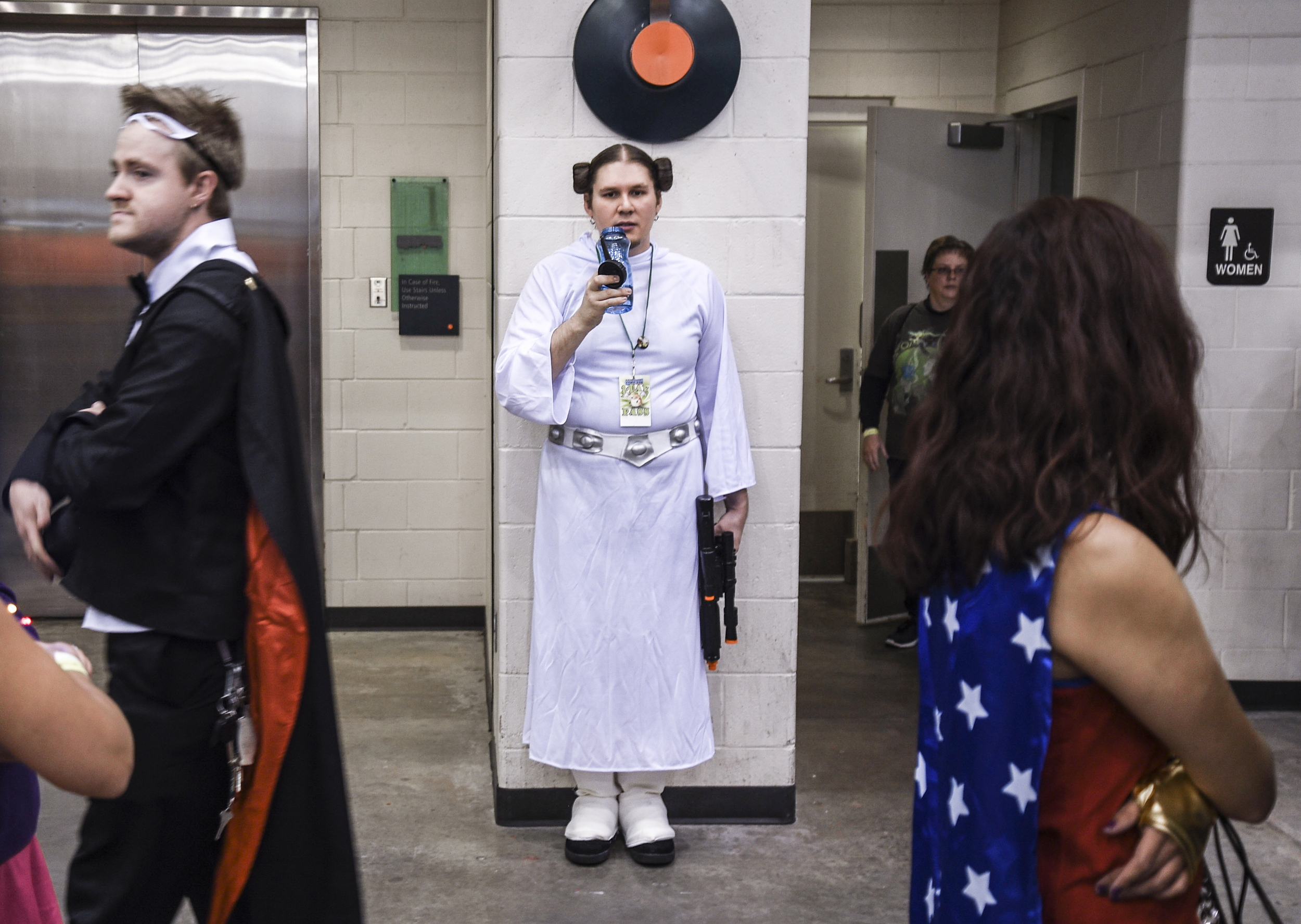  Andrew Perry, dressed as Star Wars' "Princess Leia", waits for his wife outside the women's restroom during Grand Rapids 2015 Comic-Con festival Saturday, Oct. 17, 2015, at DeVos Place in Grand Rapids, Mich. "My wife is dressed as Han Solo because w