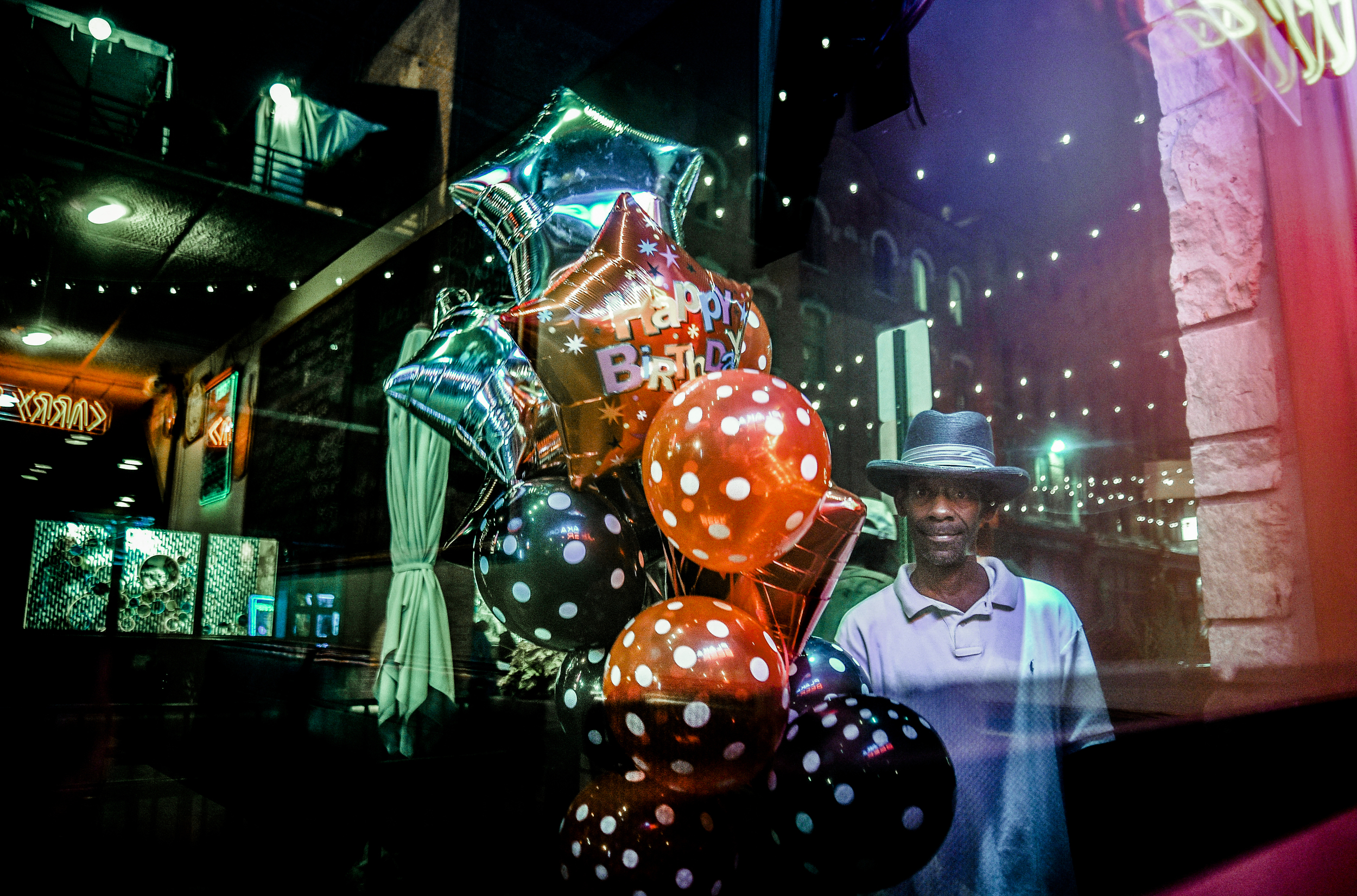  Detroit resident, John Taylor, holds his birthday balloons while posing for a portrait in Greektown after Niki's Lounge threw him a surprise party for his 53rd birthday, Friday Sept. 4, 2015, in Detroit, Mich. Taylor is a loyal and regular customer 