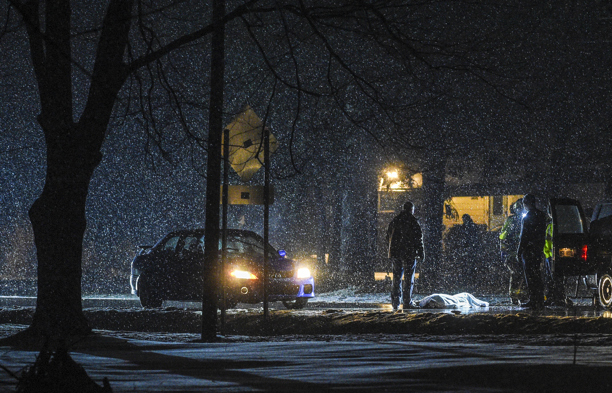 Walker Police cover the deceased body of an 84-year-old man after he was struck and killed while attempting to cross Wilson Avenue Tuesday evening, Dec. 29, 2015, in Walker, Mich. The 19-year-old driver attempted to stop, but could not avoid strikin