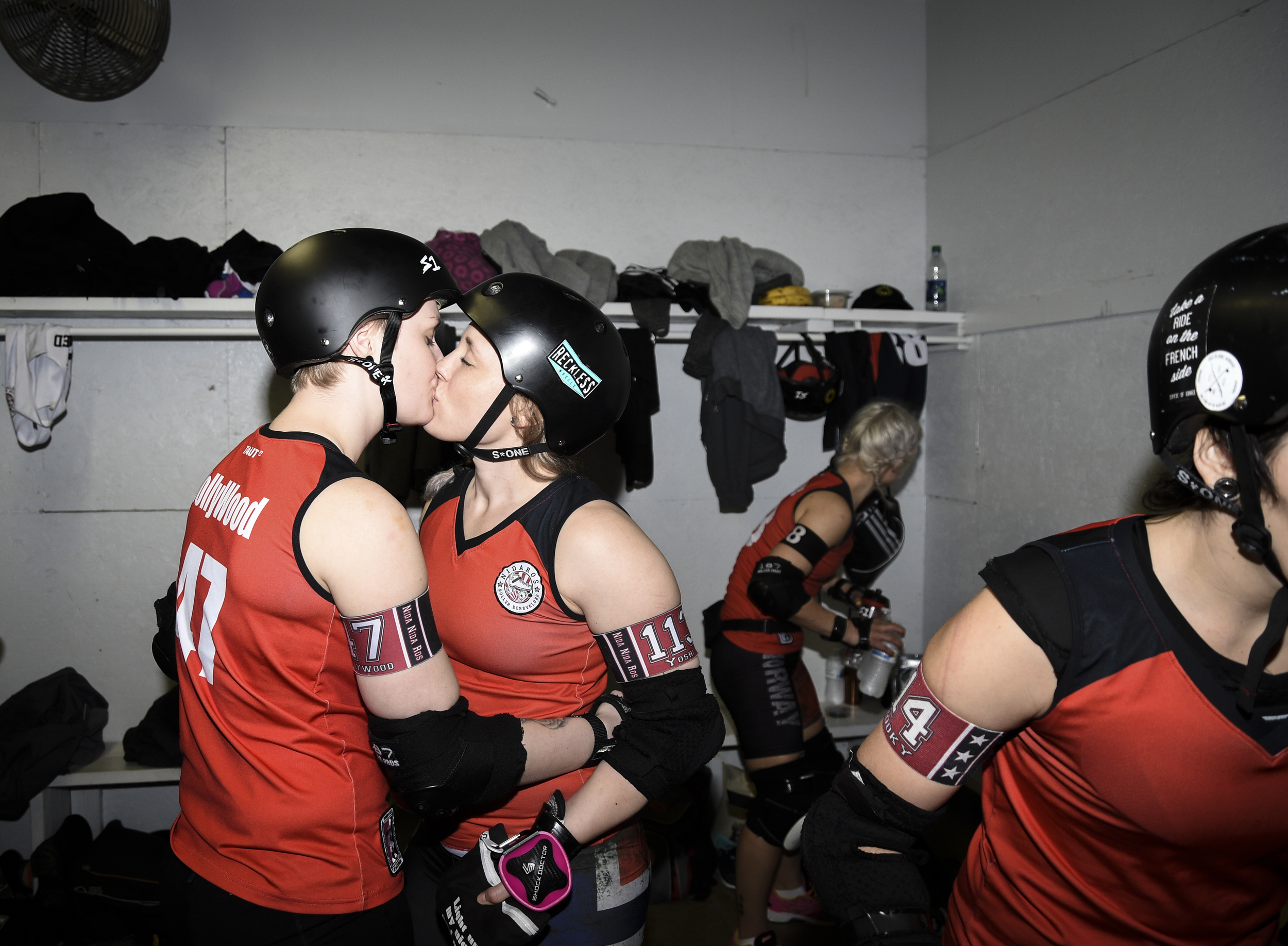  Camilla Skog, derby name "Jollywood" (47) kisses her girlfriend and teammate Monica Kristoffersen, derby name "Yoshibitchu" (113) from Norways' Nidaros Roller Derby in the the locker room before playing Grand Raggidy Roller Derby Saturday, April 9, 