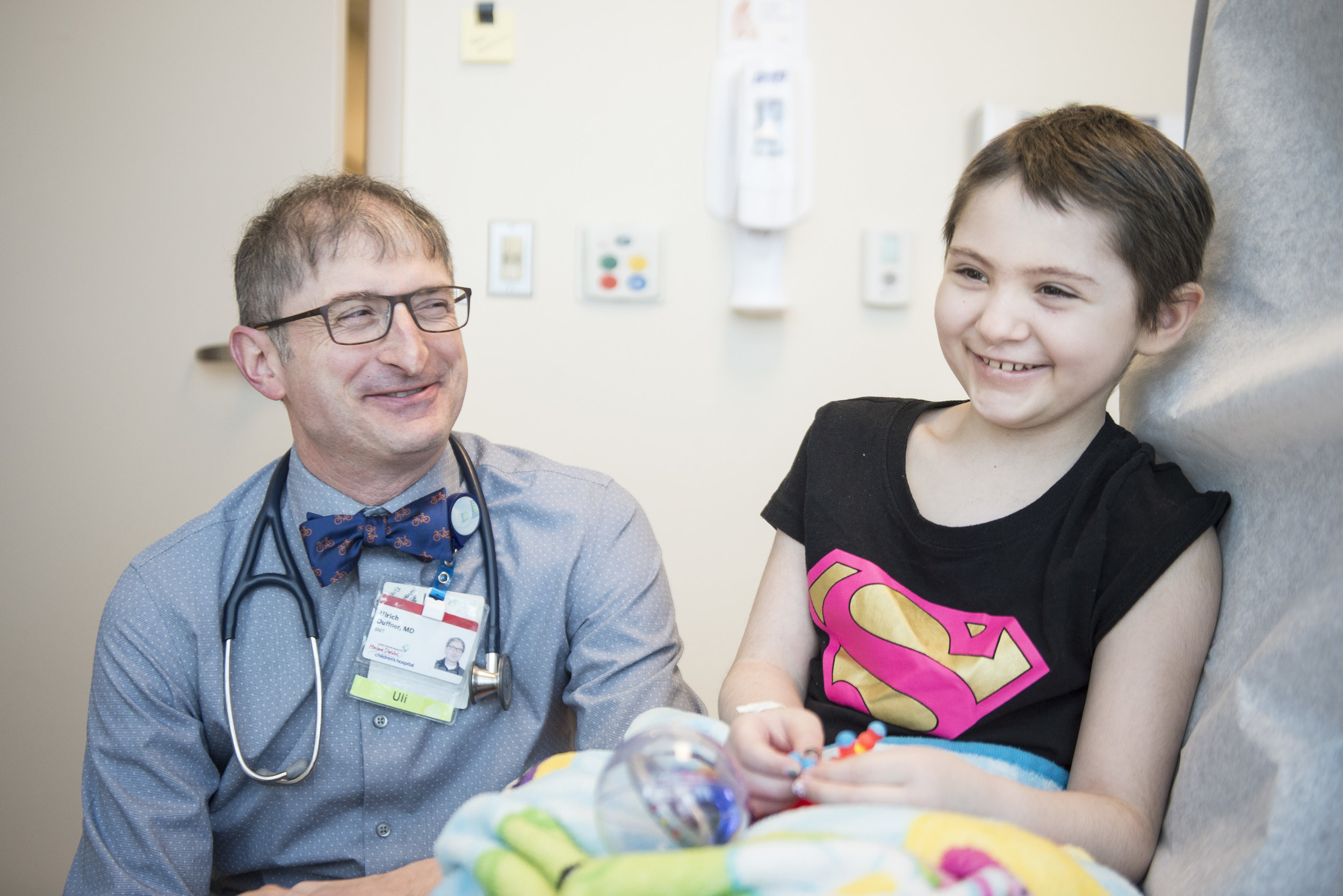  Ulrich Duffner, MD, Naomi's pediatric blood and marrow transplant specialist, laughs with her during one of her last regular appointments before going home. “She is resilient,” Dr. Duffner says. &nbsp; 