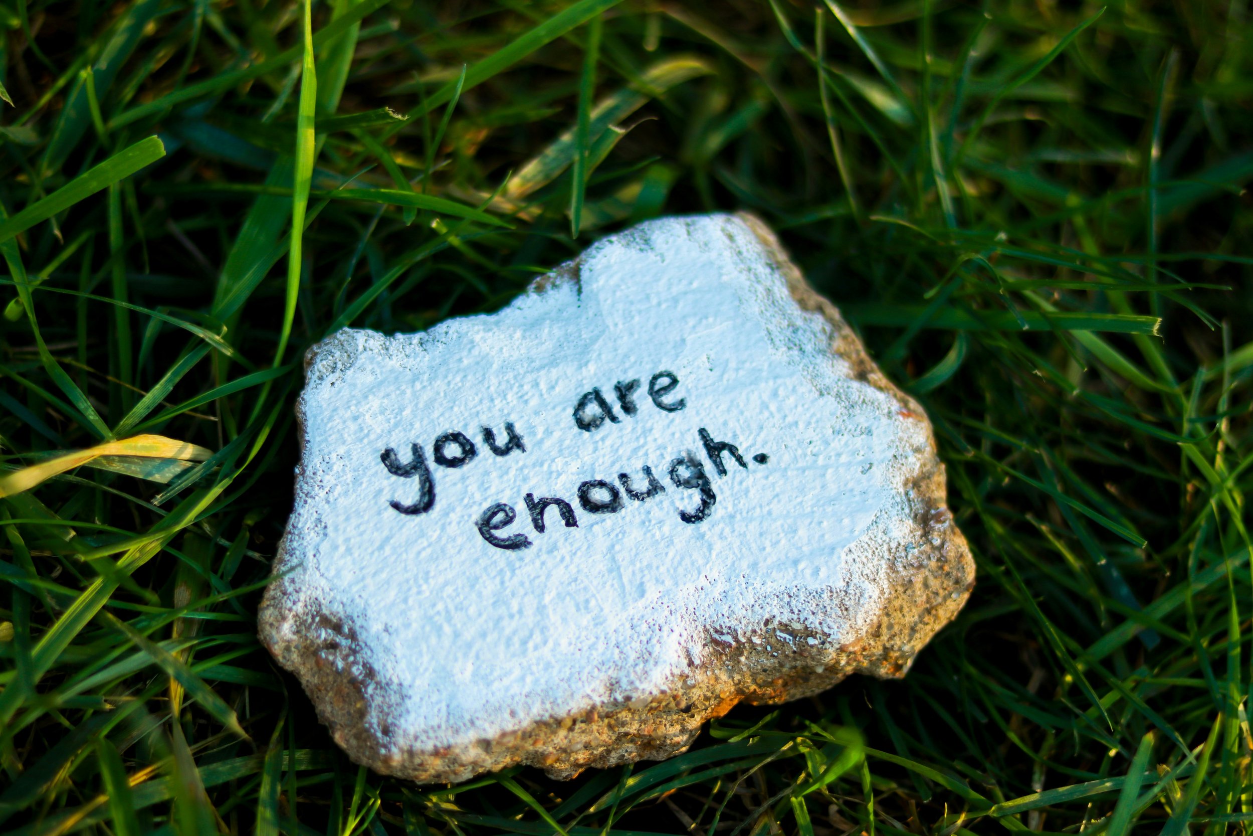 rock with the words, you are enough