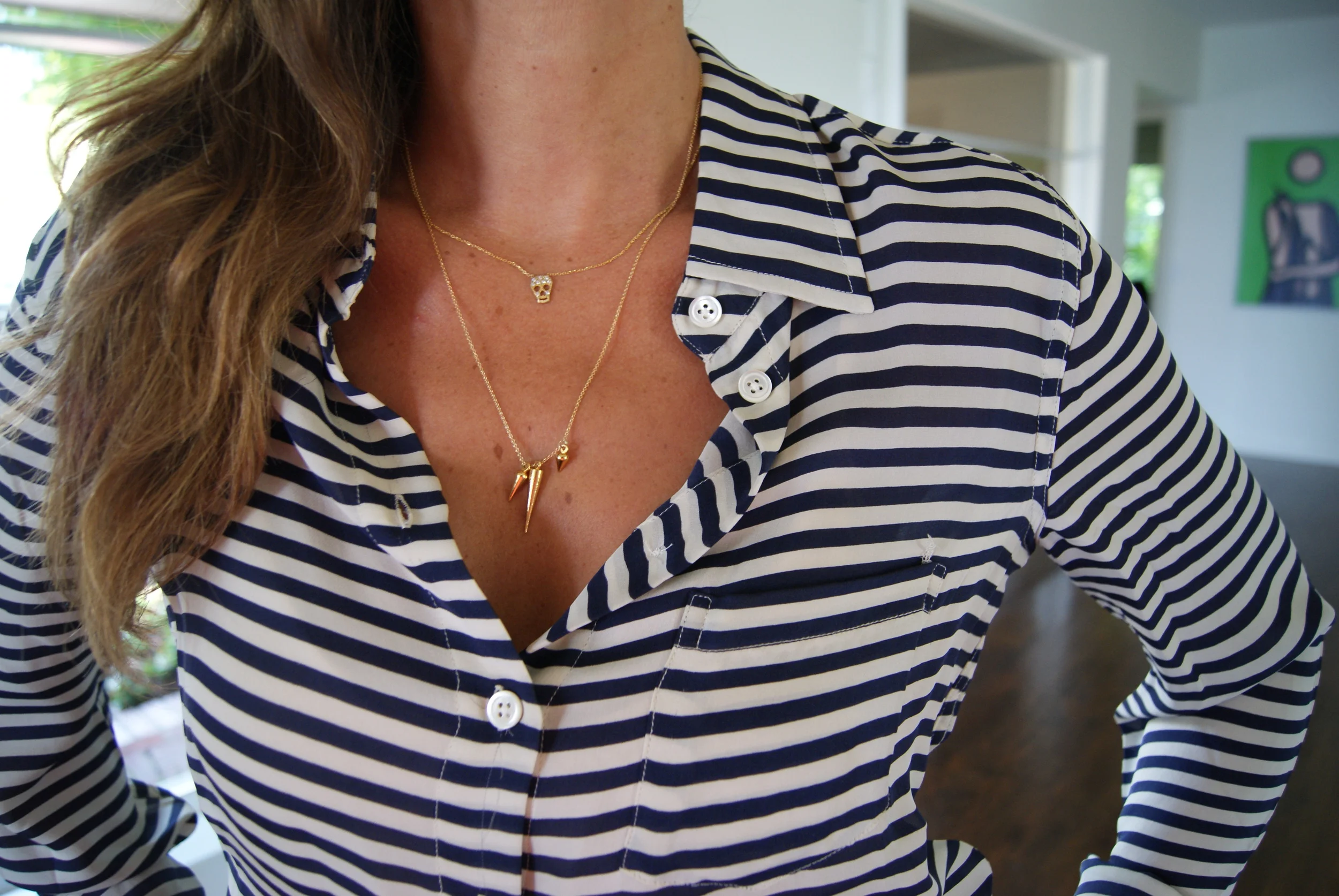 Skull necklace by Jennifer Miller jewelry, $125. Spike necklace purchased on Opensky.
