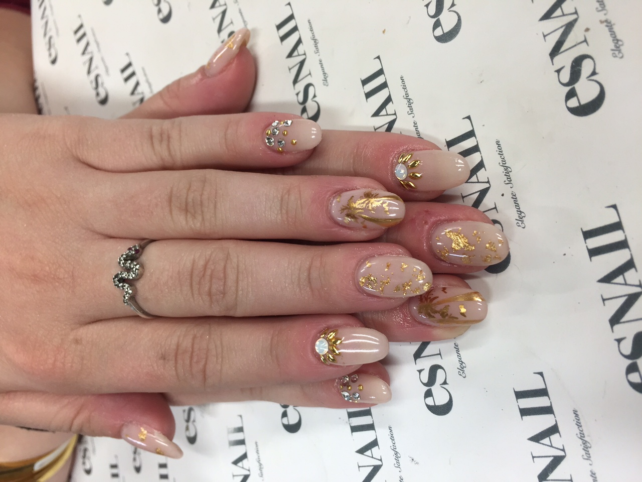 Natural nail with stones, gold and glitter. Hand model Rachel Meyers.