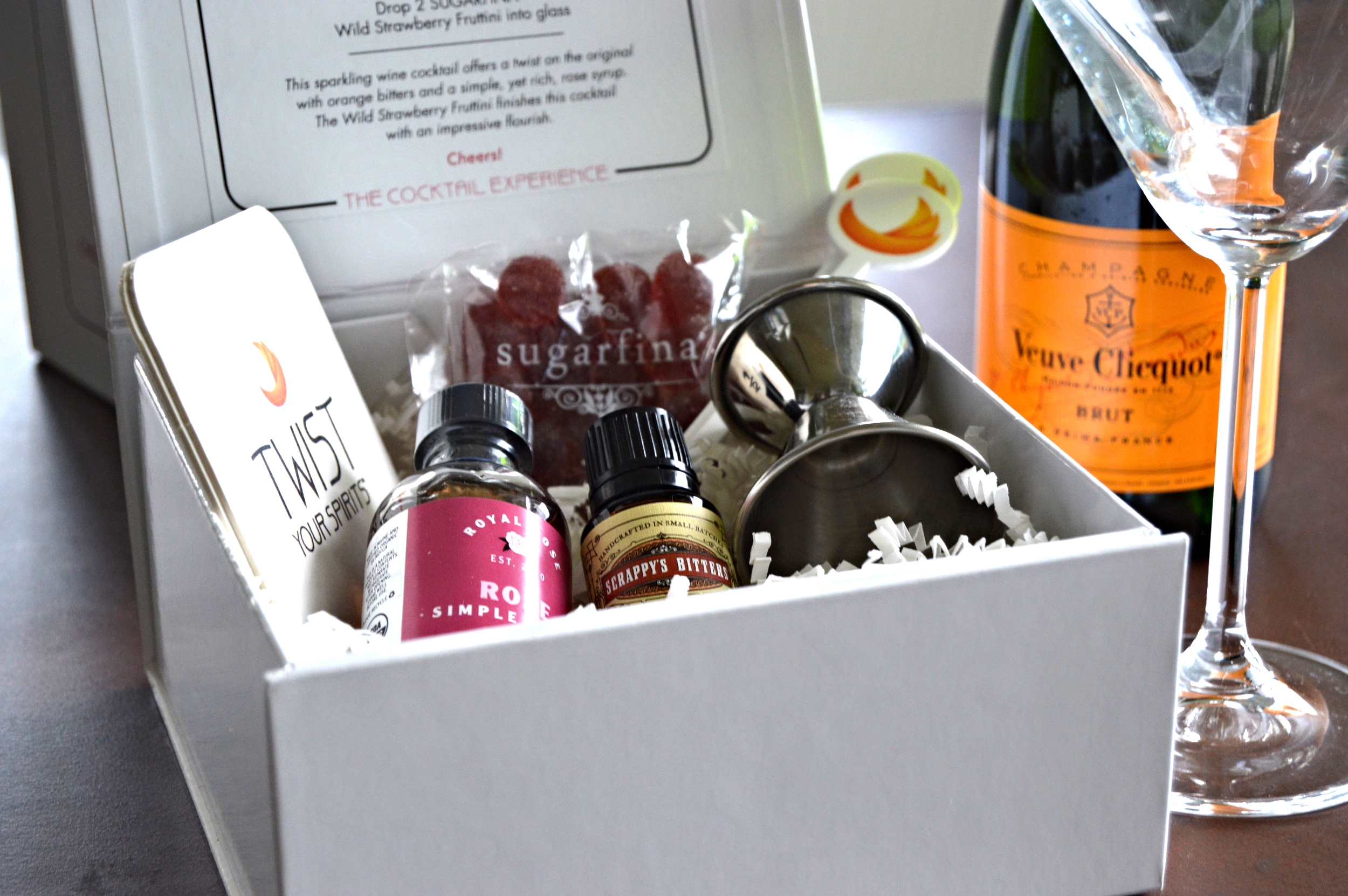 "Rose Colored Glasses" kit by Twist Your Spirits. Contains Royal Rose Syrup, SCRAPPY's Orange bitters, SUGARFINA Wild Strawberry Fruttini, One Jigger, Two Cocktail Stirrers and Two Coasters. Serves 4.