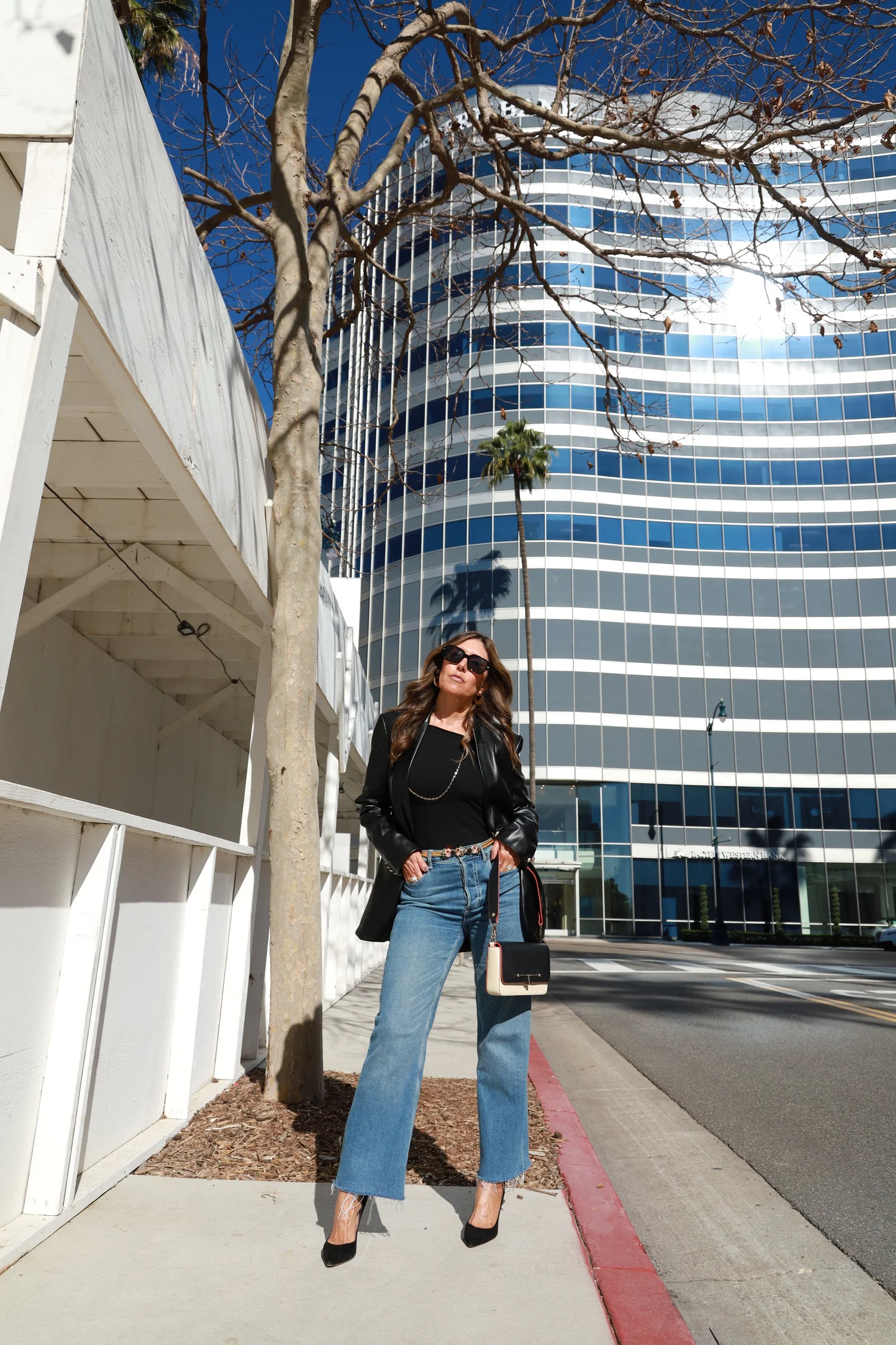 Woman over 50 wearing relaxed jeans with a polished jacket