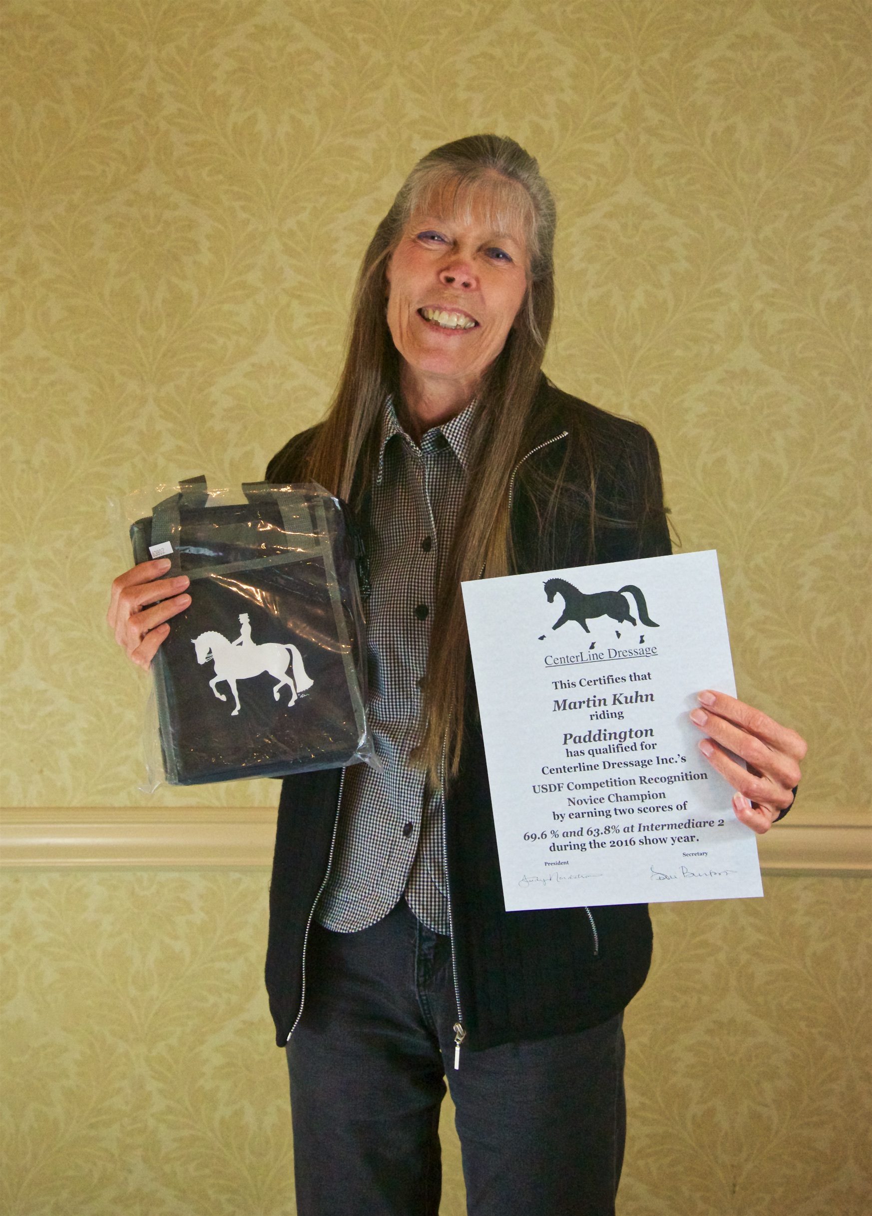 Owner Leslie Burket receiving her Intermediare II Novice Champion Award