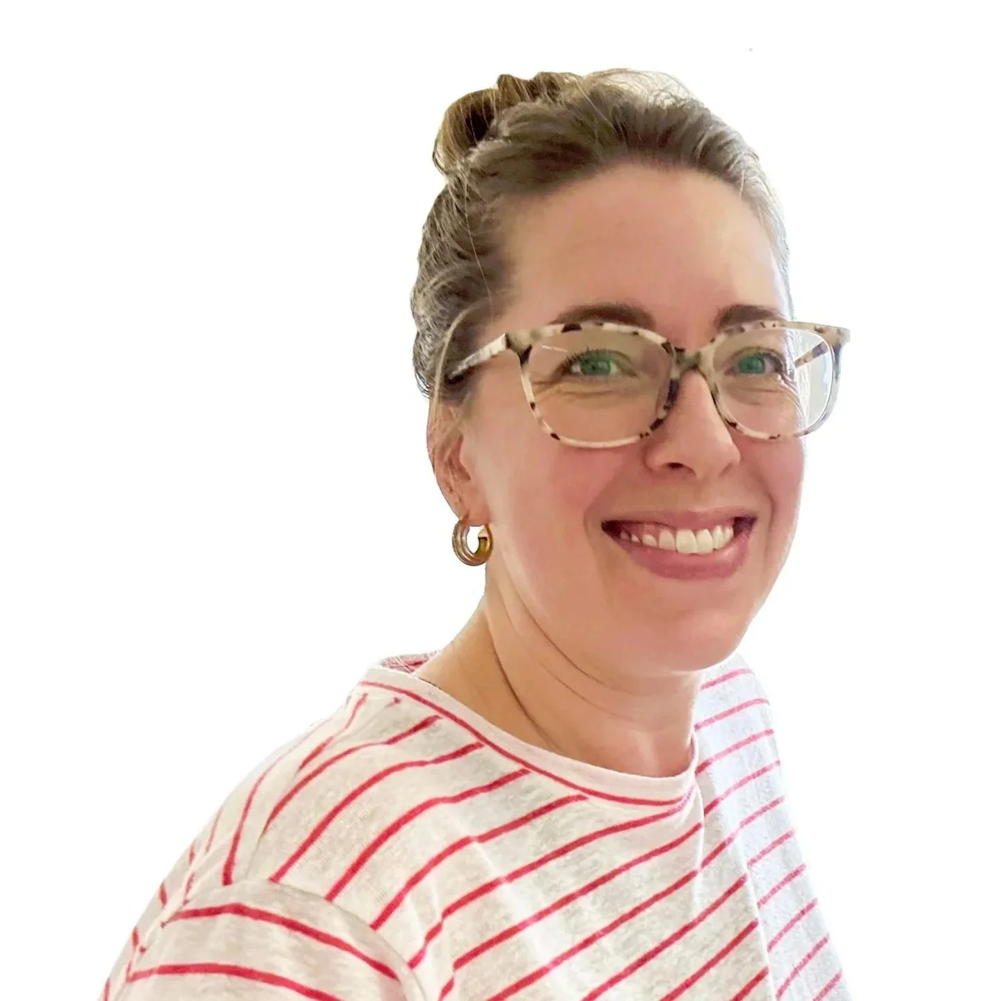 The artist Cassandra Smith with brown hair in a bun, wearing large tortoiseshell glasses, gold hoop earrings, and a white t-shirt with red horizontal stripes, against a plain white background.