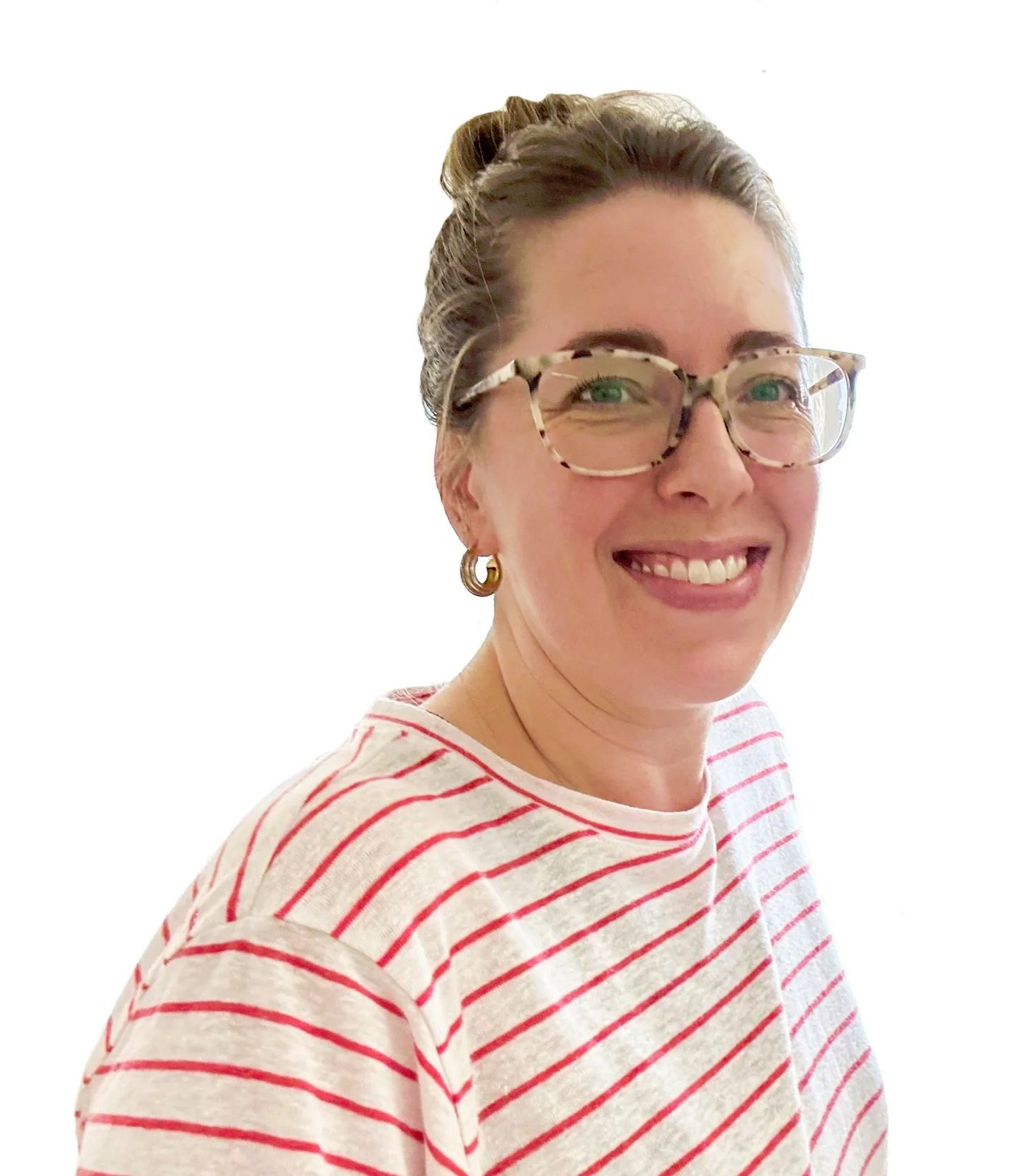 Artist Cassandra Smith with glasses smiling, wearing a red and white striped shirt, gold hoop earrings, with her hair in a bun, against a plain white background.