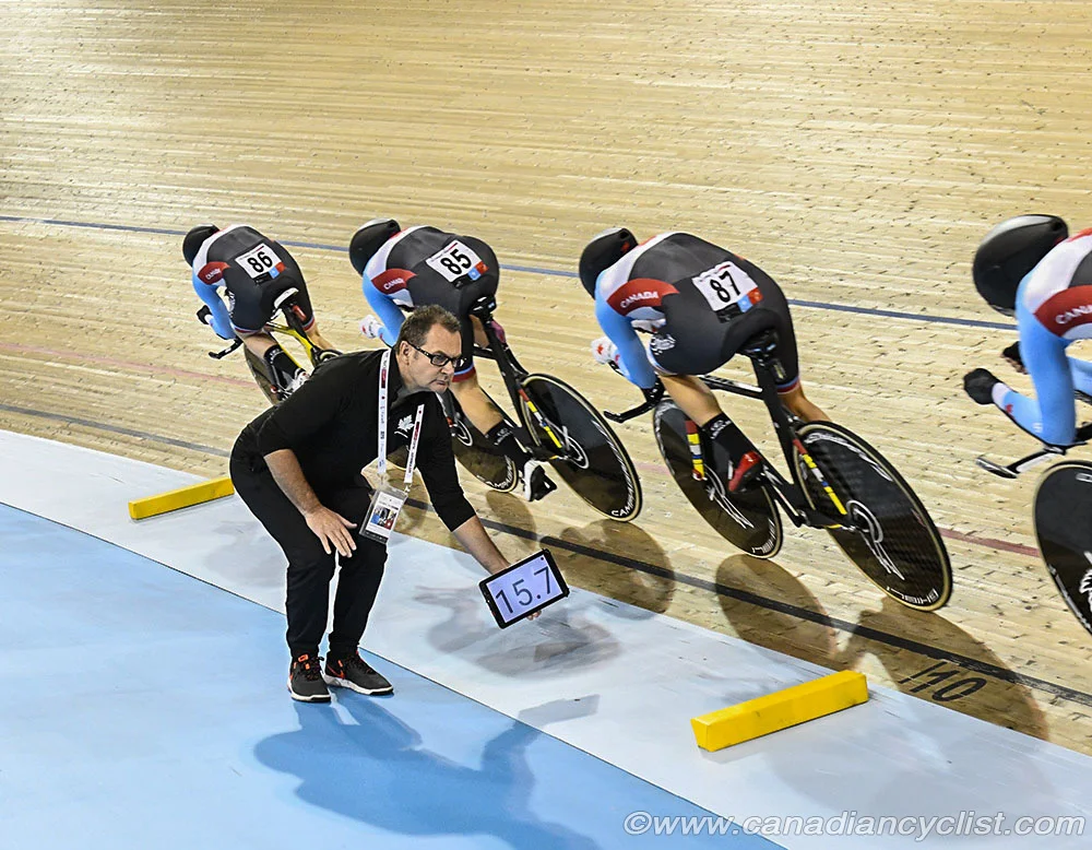 Women's endurance coach Craig Griffin gives feedback to the team. (photo by Rob Jones)