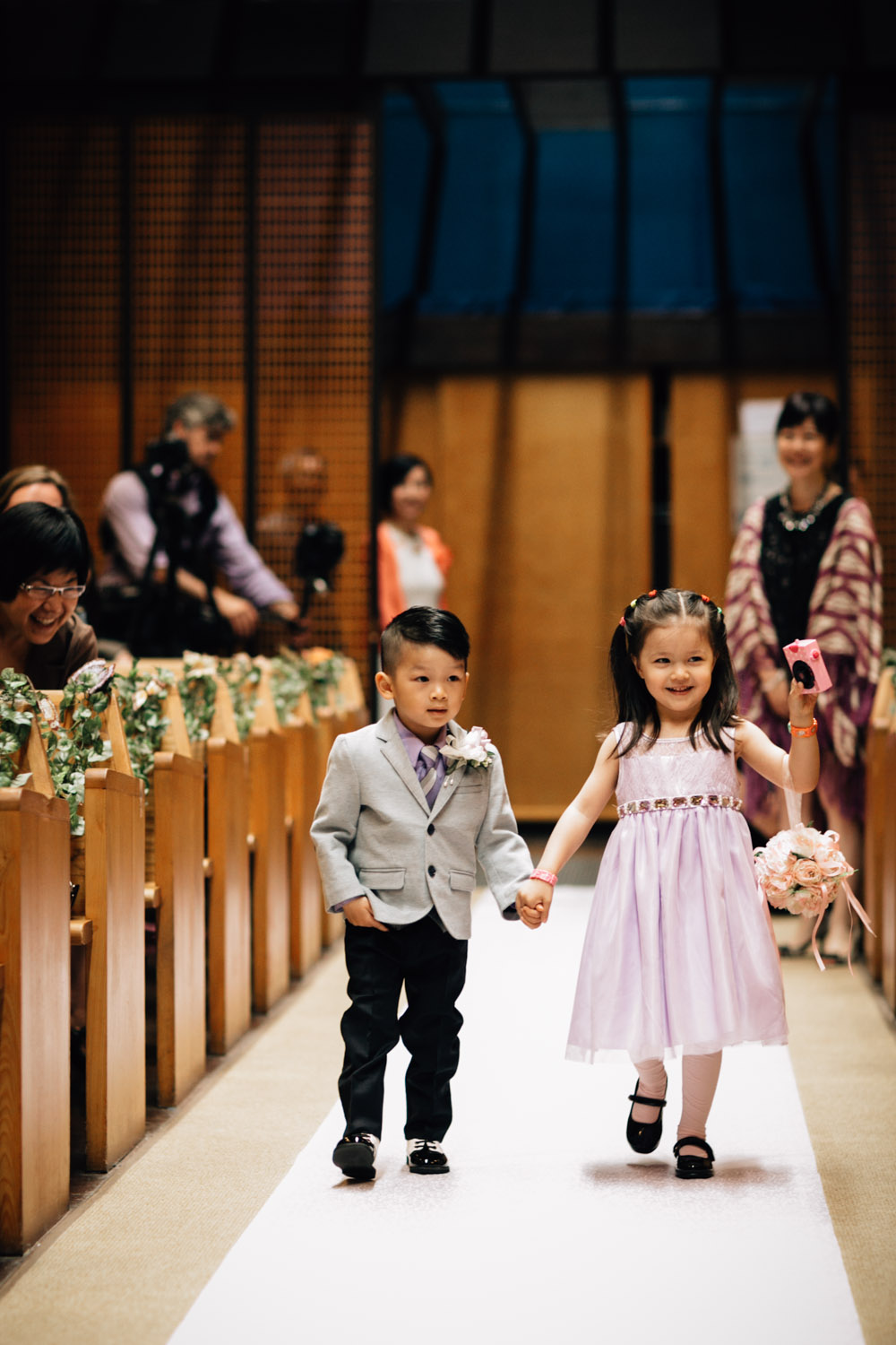 ring bearer and flower girl walk down aisle of redeemer lutheran church vancouver wedding photography