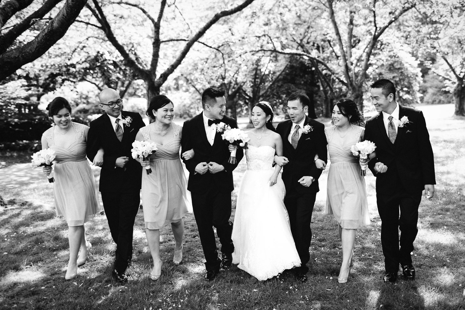 bridal party walking in stanley park rose garden vancouver wedding photography