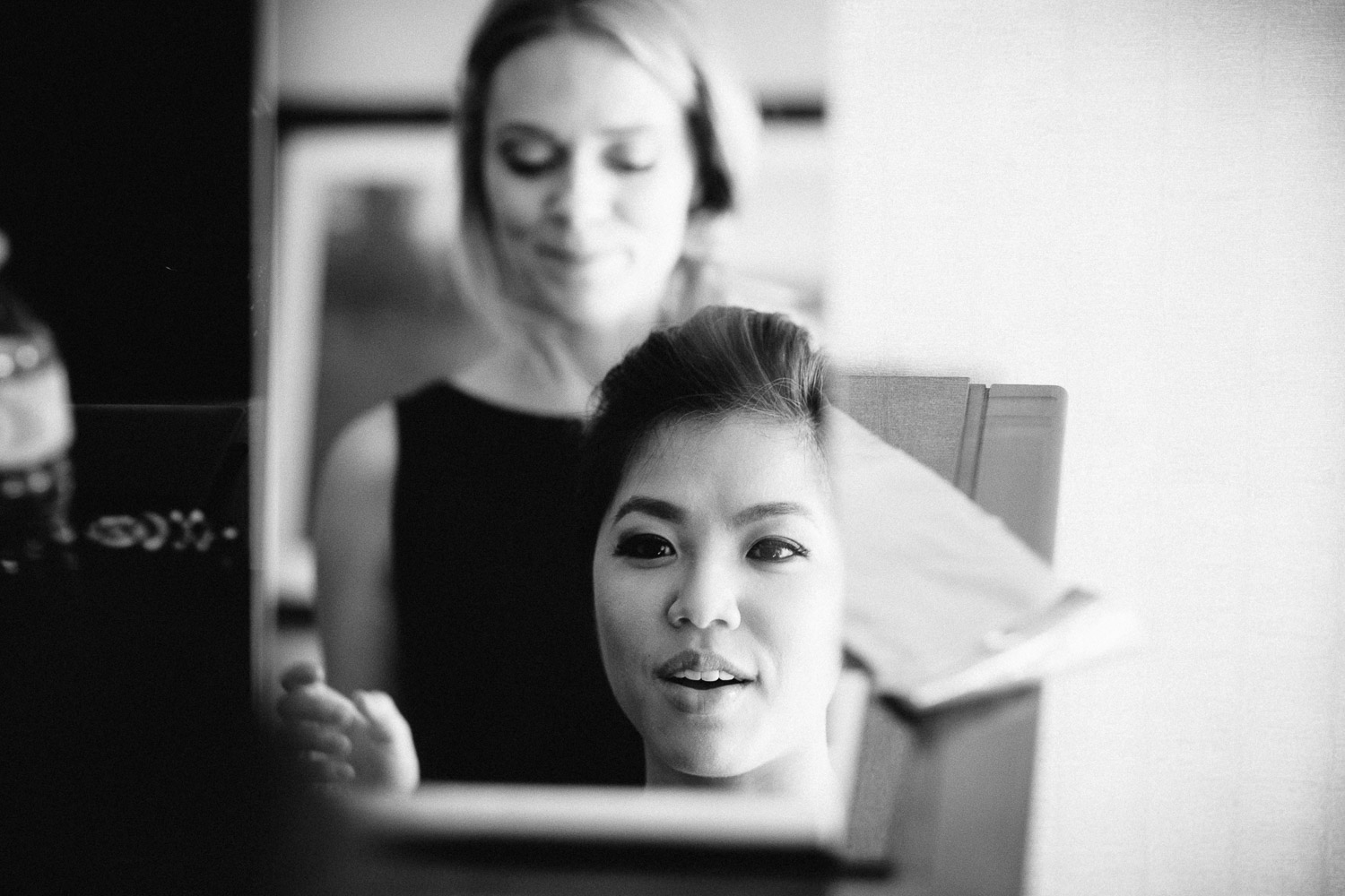 bridesmaid putting on makeup in surrey sandman hotel for wedding