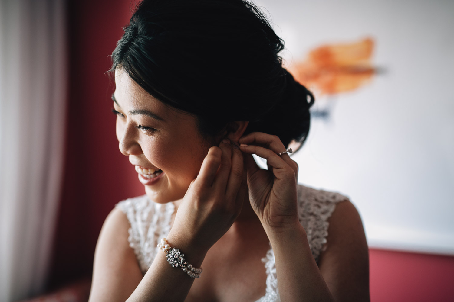 bride putting on earrings for wedding in yaletown vancouver bc photography