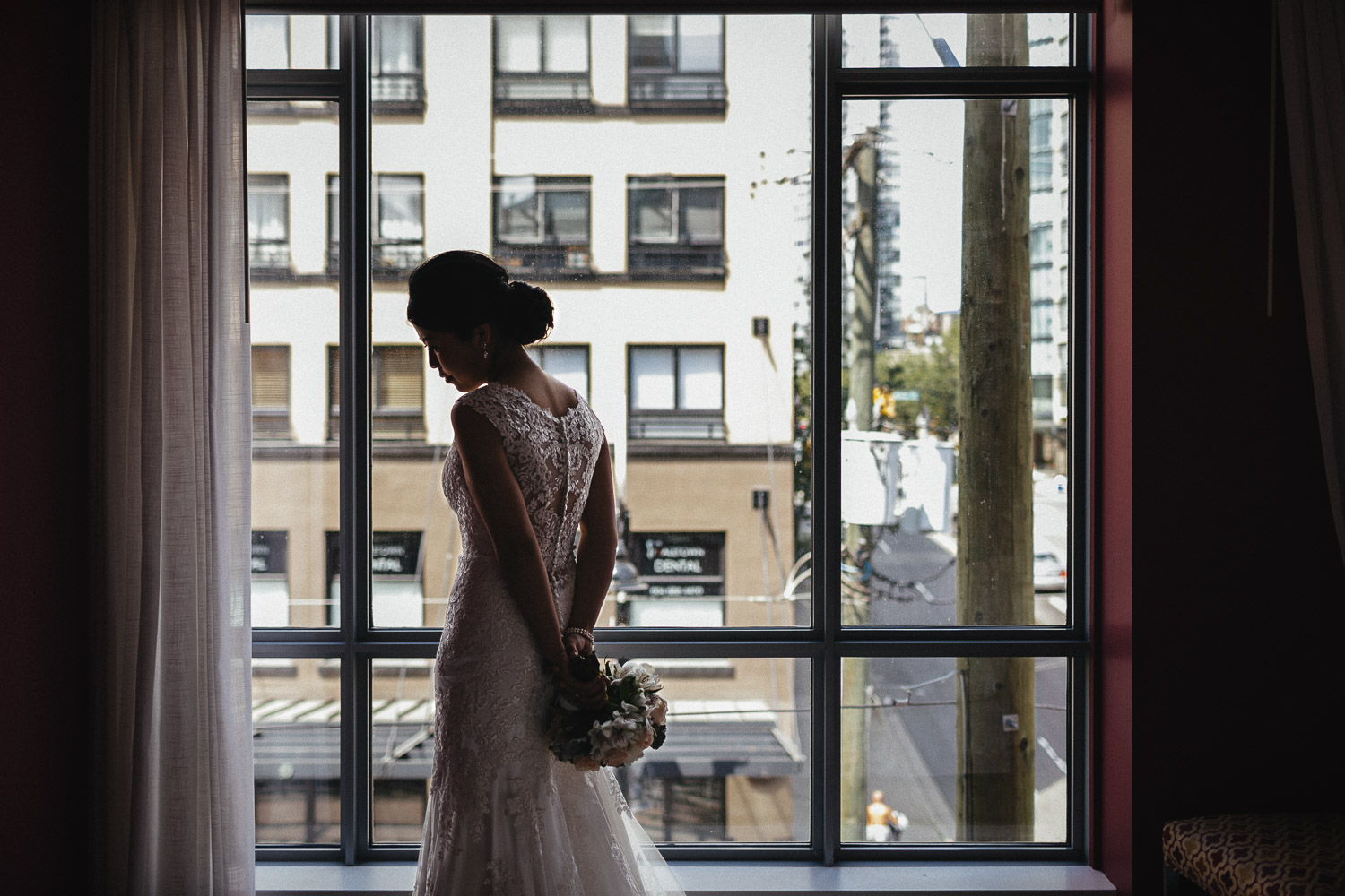 bride by window in opus hotel yaletown vancouver bc wedding photography