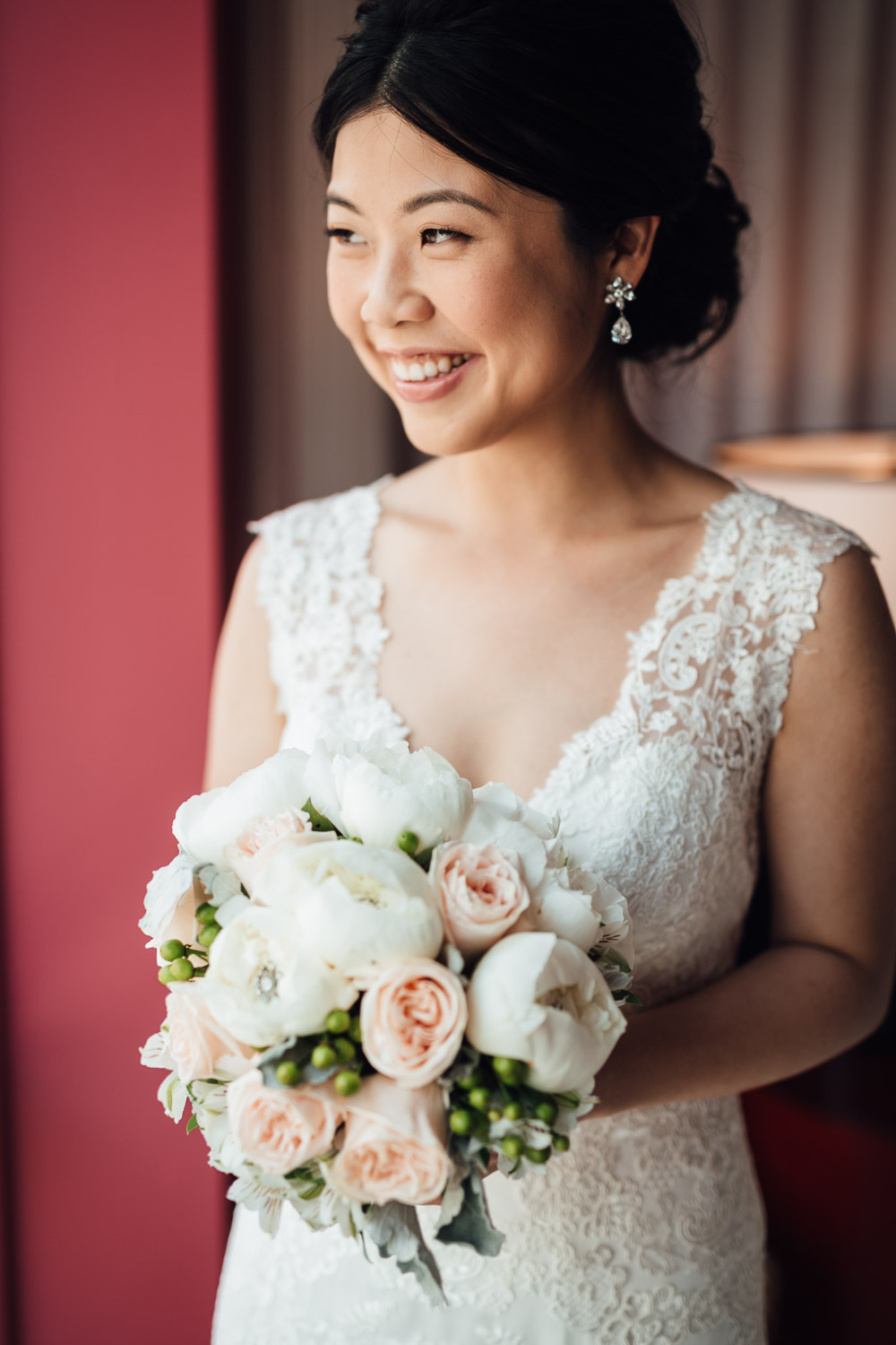 bride looking out window with bouquet vancouer wedding photography