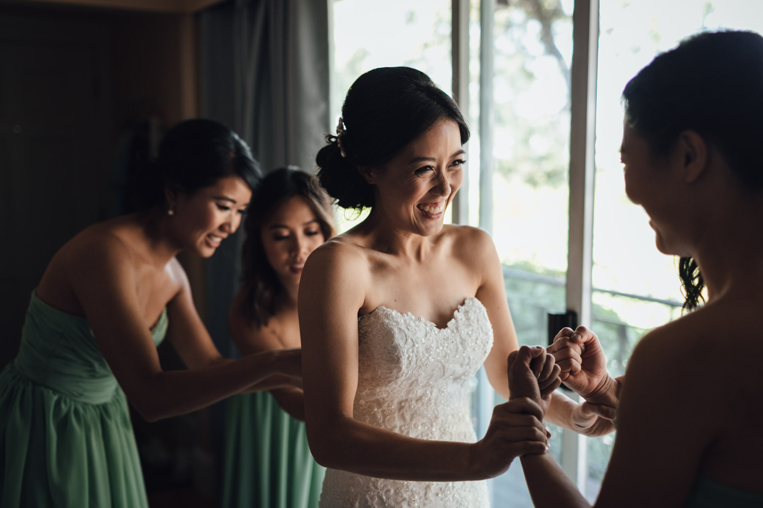 bride putting on wedding dress in vancouver wedding photographer