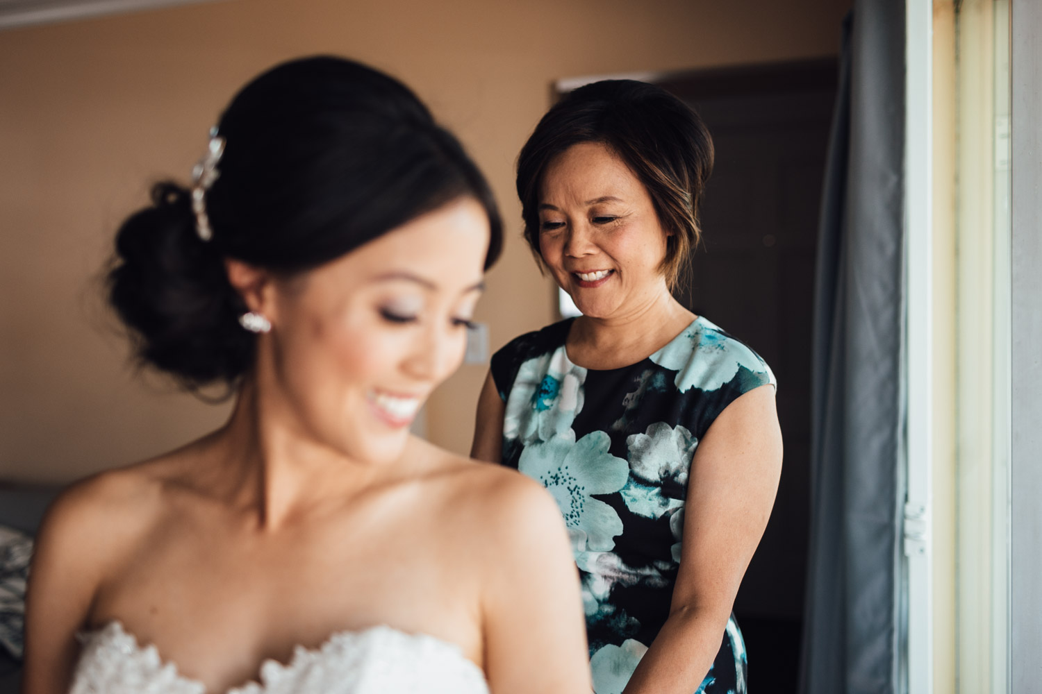 east vancouver wedding photography mother doing up wedding dress