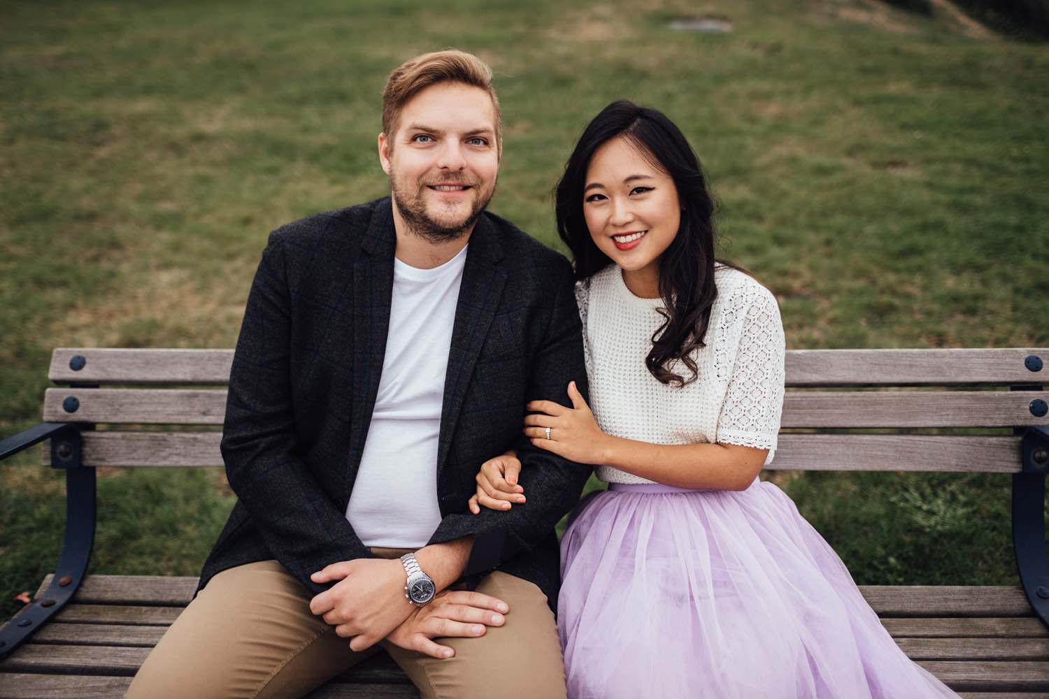 north vancouver couple sitting on bench laughing candid engagement photography pinterest