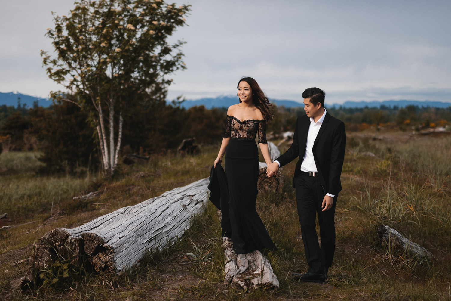 windy engagement photography during sunset at iona beach in richmond bc