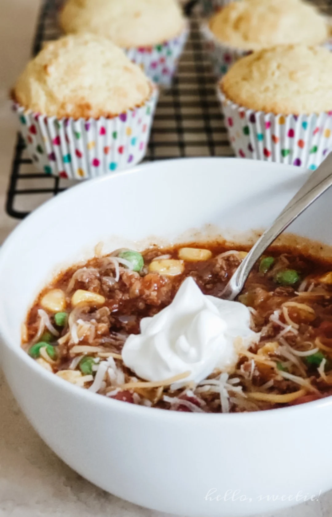 the best chili ever; always served with shredded cheese, a cool dollop of sour cream and lots of warm corn muffins!