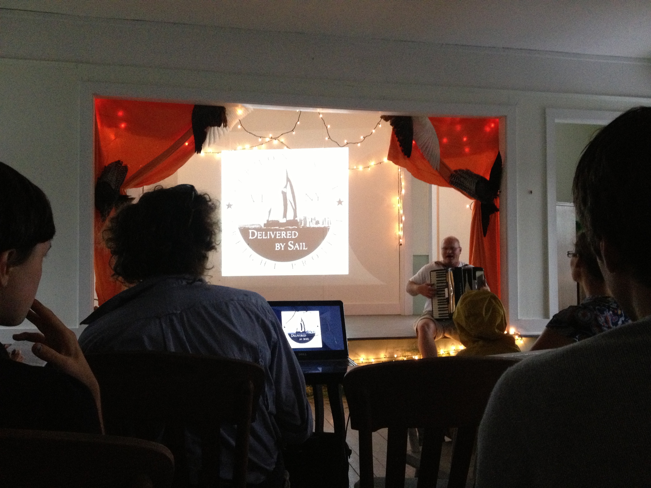  Back at the Ausable Grange, we heard a talk from Eric Andrus (seated with accordion), founder of the  Vermont Sail Freight Project . His vision is to have a fleet farmer-owned sail-powered barges moving goods from farms up around Lake Champlain down