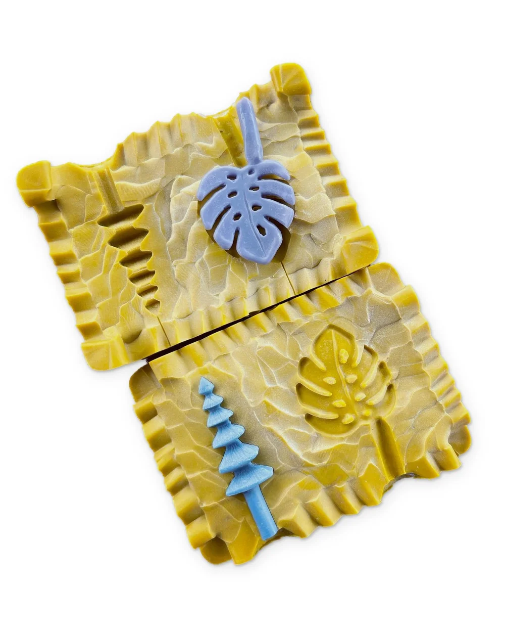 Blue wax models of LucasPlus pendants in open rubber molds, ready for lost-wax casting