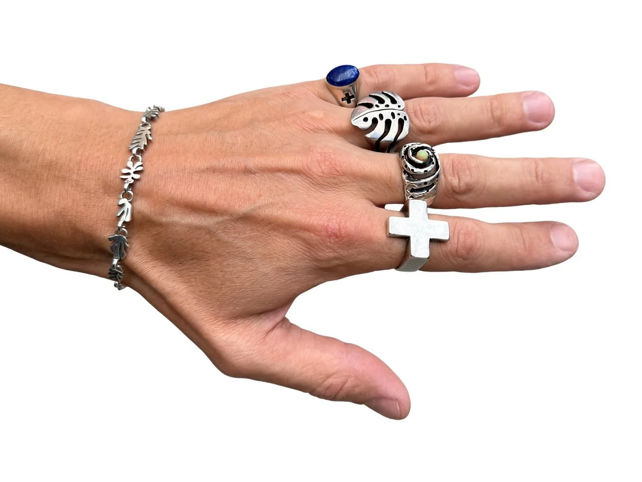 Hand wearing the sterling silver Plus Ring with Galaxy, Monstera and Lapis signet rings and a leaf bracelet