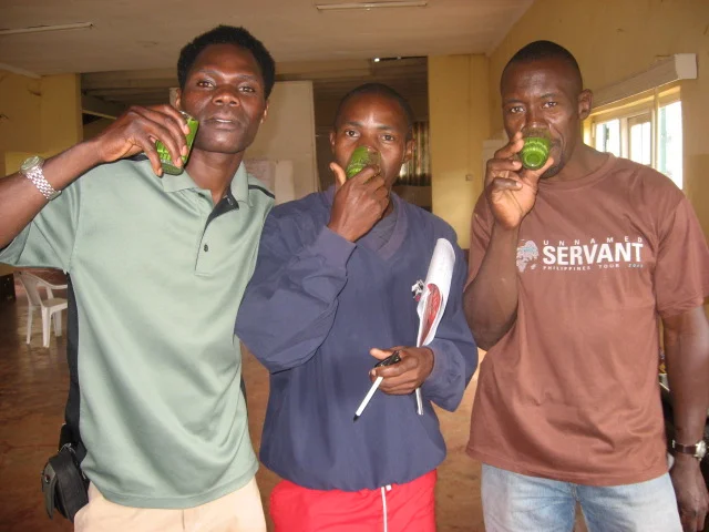 Rueben Ndwiga, of Kenya, Francis Lubega and Peter Kimbugwe, of Uganda, enjoy a freshly made smoothie after receiving a lesson on how to store and preserve food in times of scarcity.