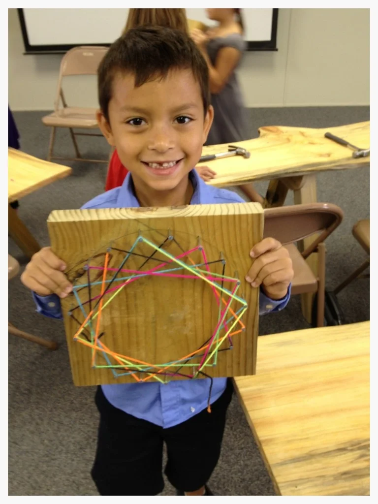In “Building Fundamentals” class, students practiced using a hammer and nails to complete a project that introduced basic geometry, mathematics, and design.