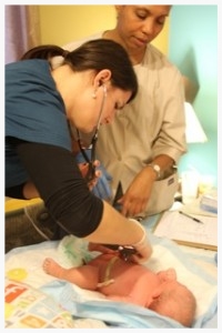 Elise Buckner performs a routine newborn exam at a home birth, with the guidance of experienced CPM, Talitha Mills.