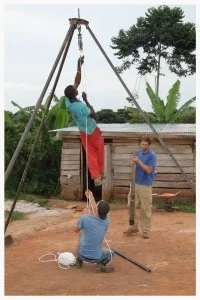 Josh Kurtz and Ugandan Cooperative Peter Kimbugwe designed and constructed this tripod structure for lowering and bringing up loose parts out of dysfunctional wells. Though Kurtz was the individual originally trained in well repair, he passed on his knowledge to six other African men who are now empowered to repair them, even when Kurtz is not present. 