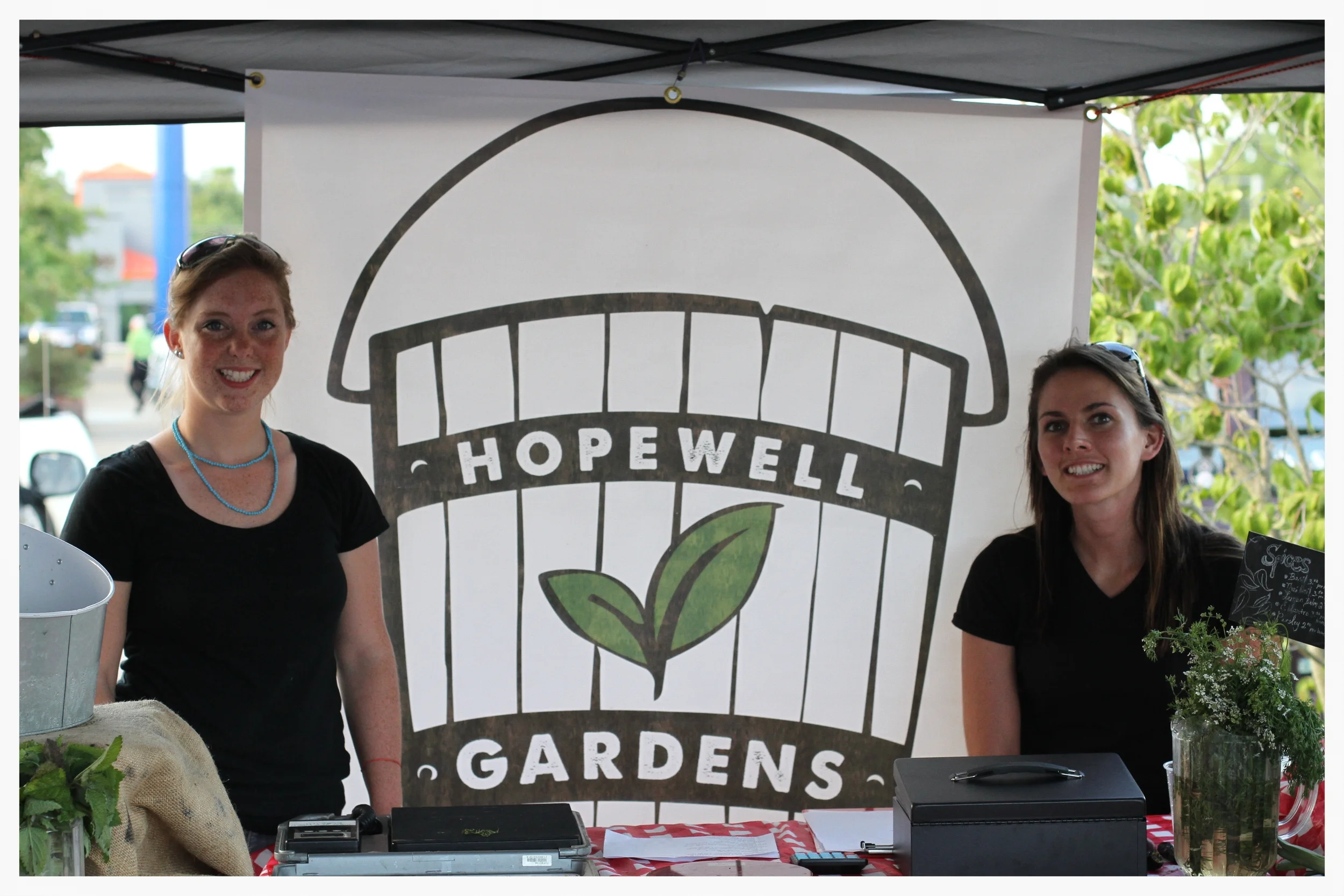 Breann Bennecker (left) and Rachel Webb (right) are forming relationships with the local community through their weekly stand at the Donelson Farmer’s Market.