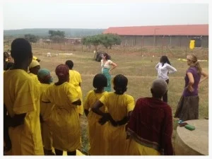 Kim was able to teach stretching, body positioning, and give massage therapy at a woman's prison in rural Uganda. Here, the women learn the benefits of good posture, and practice it together.