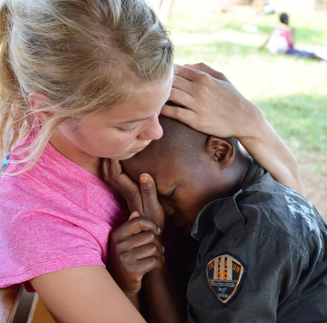Laura Foster, one of Miller’s teammates, held Apollo while he suffered the pains of a headache from malaria. The loving touch is an important and essential part of treatment. Humanizing care and compassion is often missing in efforts to bring healing. People are not problems to be solved, but persons to be served.
