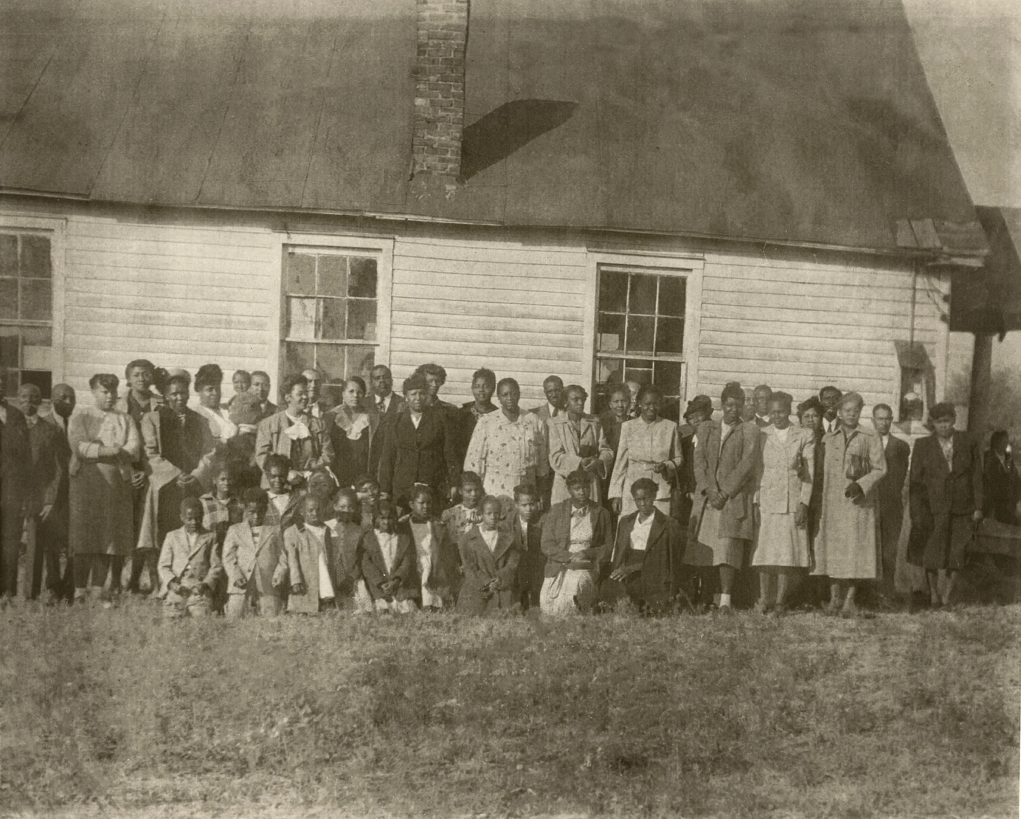 Circa 1930 - Hopewell residents standing outside 1st Baptist Church of Hopewell. Although many of the Hopewell families represented in this picture have moved out of the ‘old neighborhood,’ there are still children and grandchildren of some of the original Hopewell families living in the neighborhood. It is those children, now elderly, that we are privileged to serve.