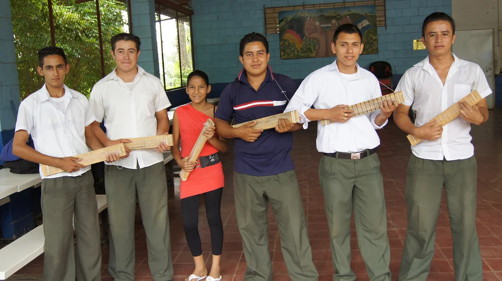While Rafael Reyes was in El Salvador he taught music to this eager group. He helped them make their own fret boards out of wood, nails, and string, so that they could practice at home. 