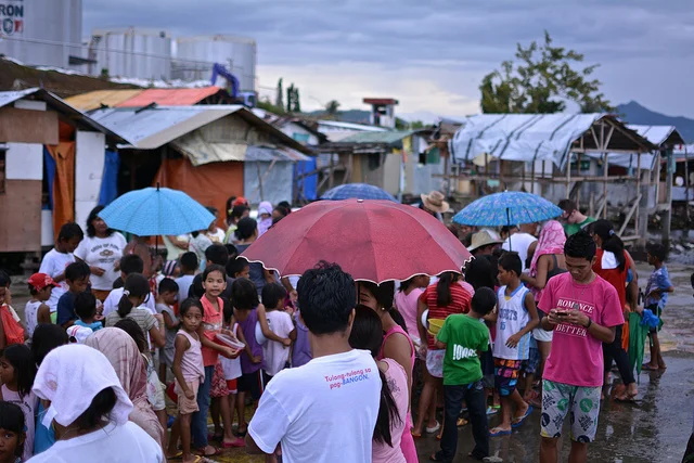 After the storm, 2.5 million were in need of food. In a land where 2 in 5 people make less than $2 per day, the recovery has been slow ( The Washington Post ). This picture (a queue of children lining up for a charitable feeding) was taken 8 months after the storm. 