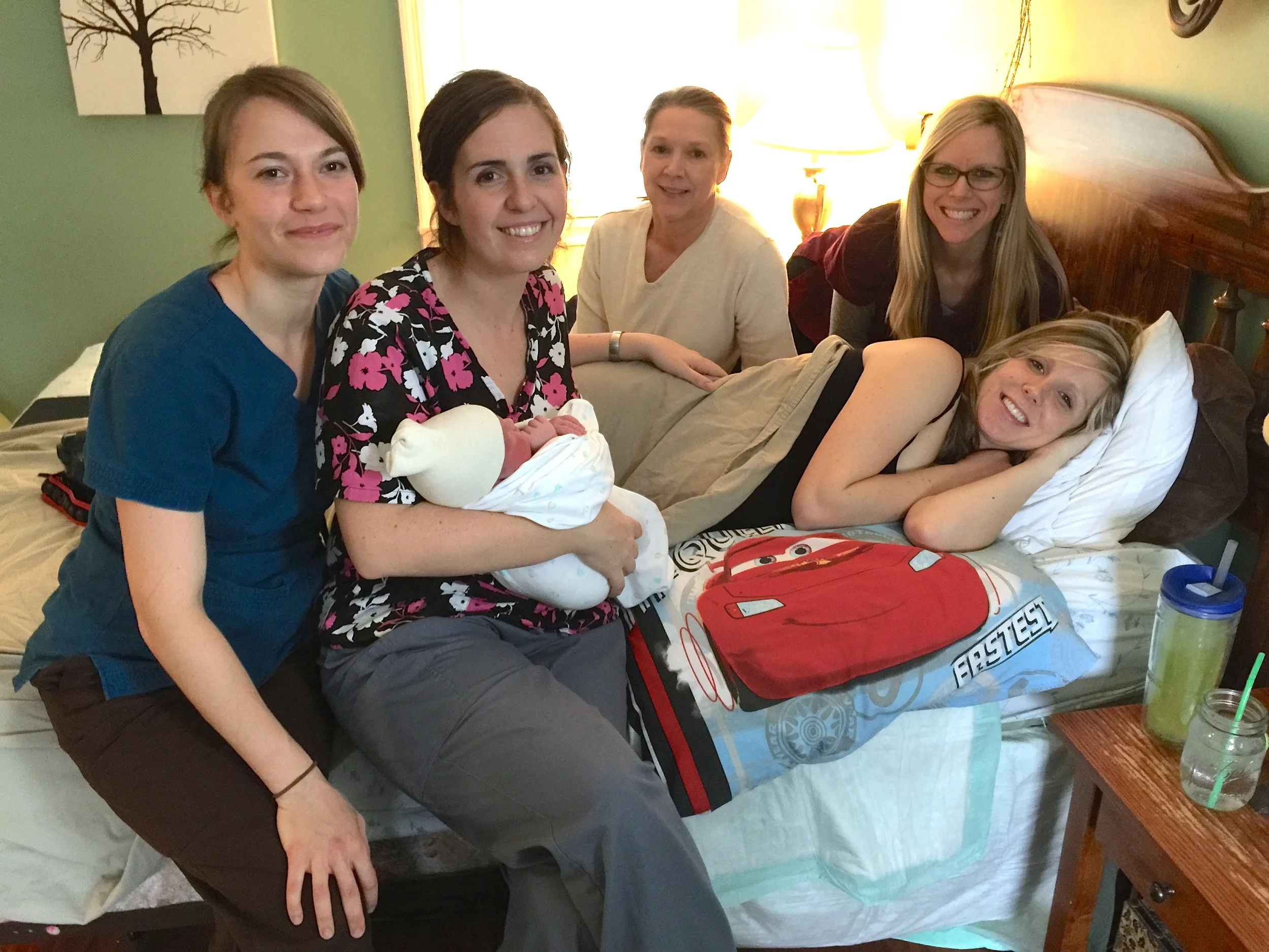 This line-up is quite impressive, from left to right: Kathryn Montgomery (apprenticing midwife), Celesta Bargatze (Certified Professional Midwife), Kathy Williams (CPM, secondary care midwife at this birth), Tara Garner (doula, Director of the Childbirth Education program at the Institute for G.O.D. Int'l, Director of NOVA Birth Services), and Meg Mathews (new mother, and apprenticing midwife). 