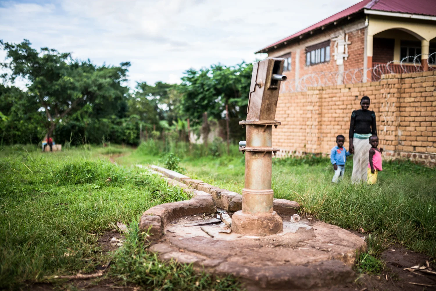 In Uganda, only 4.8% of the population has clean water piped to their property. Most people rely on gathering water for their daily needs from wells and other contaminated water sources, sometimes requiring them to walk multiple kilometers, multiple times a day, in order to get it.
