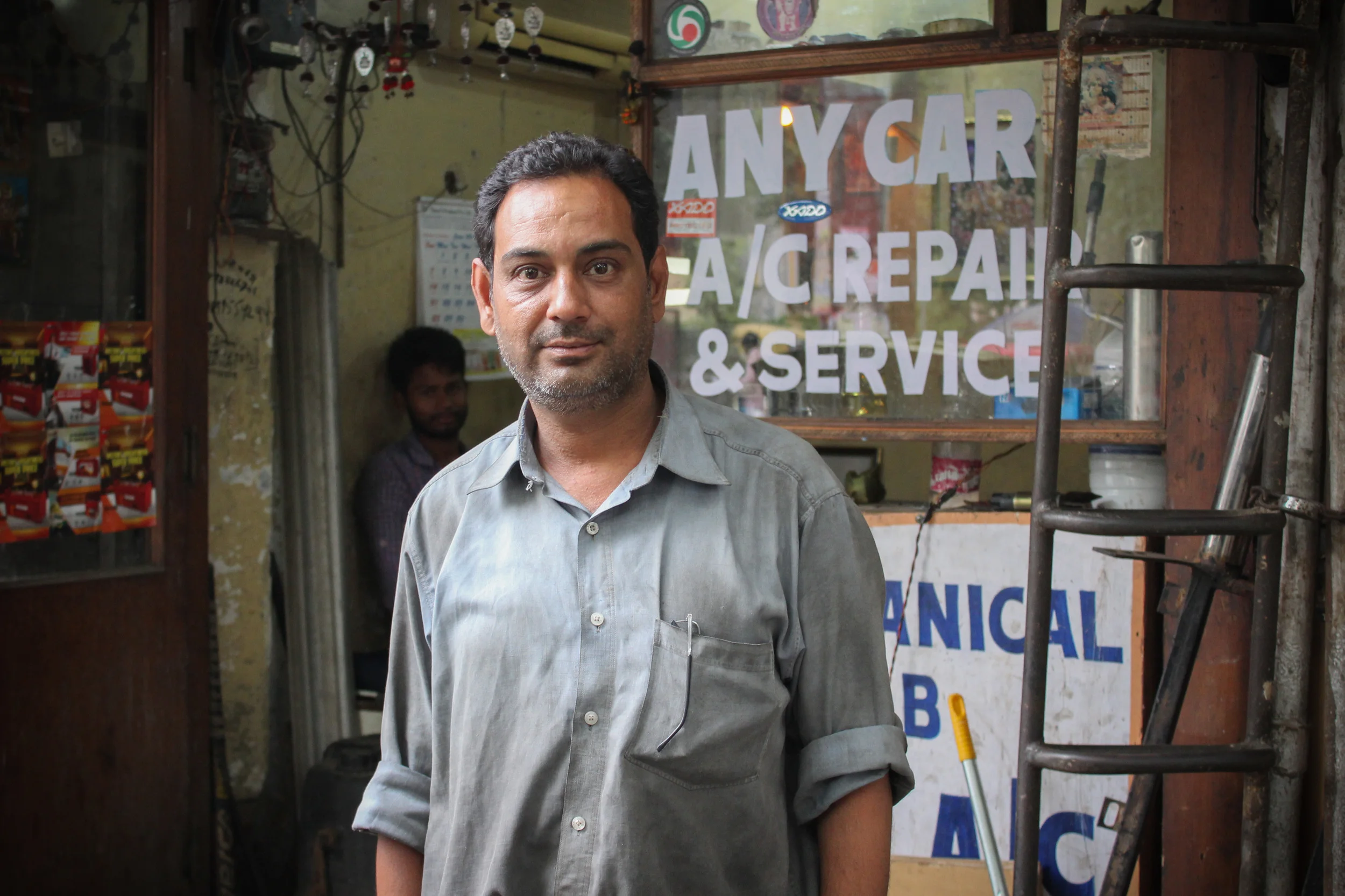 Hani, an automechanic who repairs everything from the cheapest taxi to the most expensive BMW, operates his business out of a 60 square foot office space. His "shop" is on the street in front of his office. 