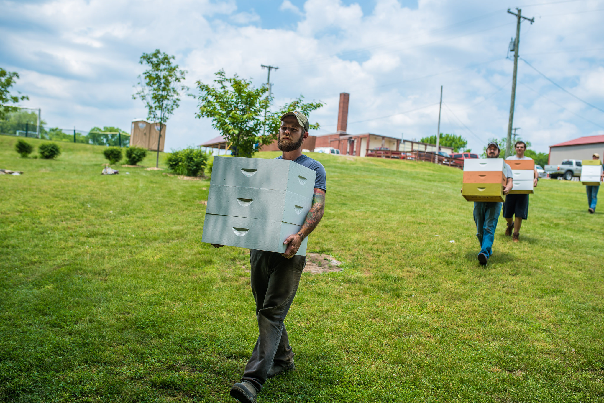 Geoff Hartnell, one of our two full-time farmers at G.O.D., helps set up the apiary in part of our newly acquired land. 