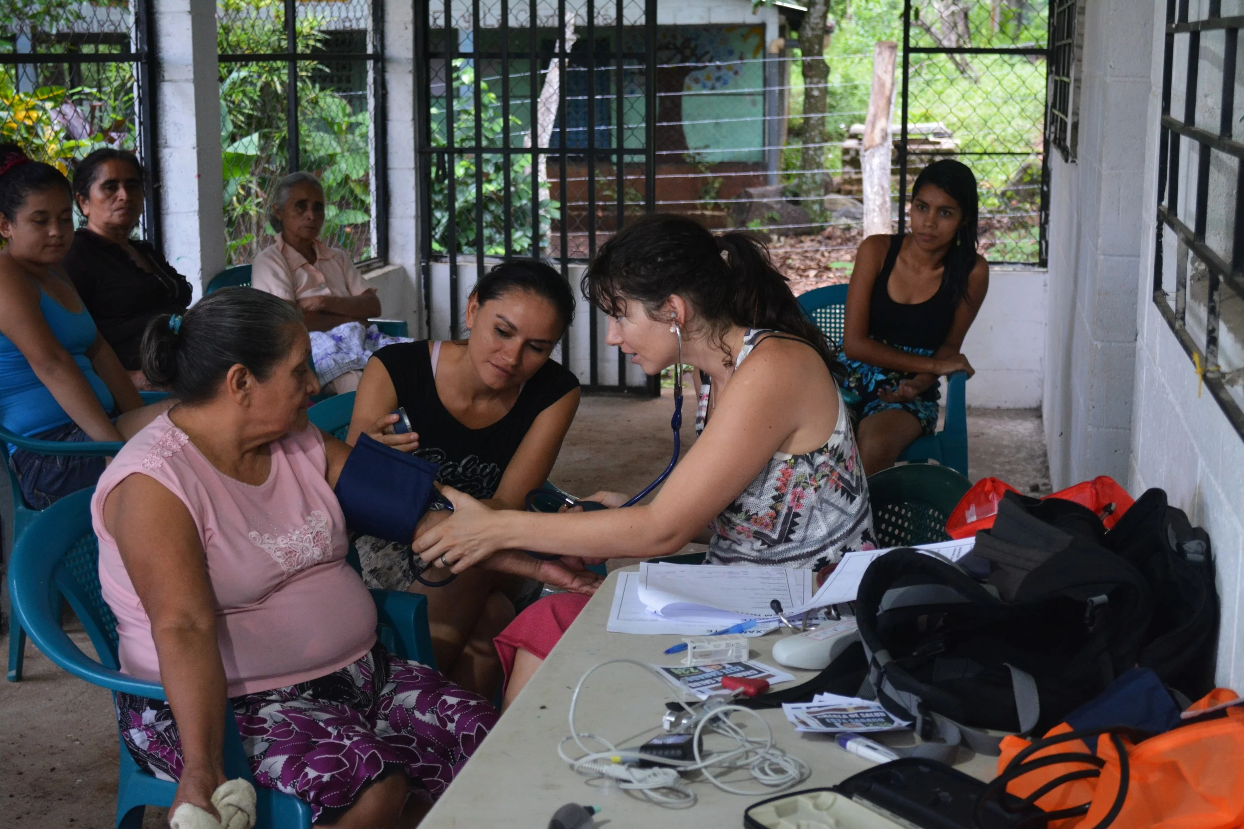 Jaimee trains Lorena on how to take vitals in her area. 