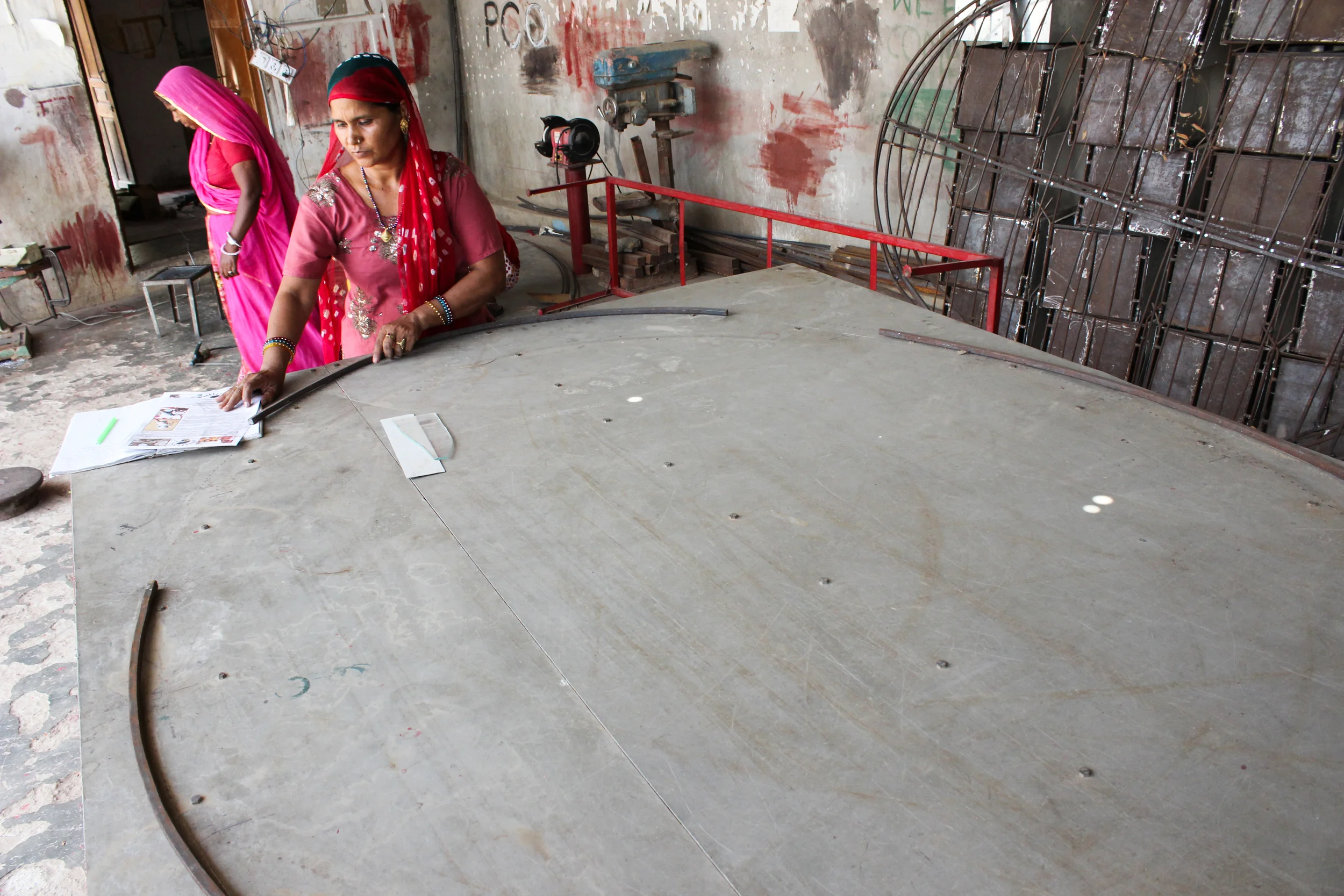 Empowering education affords the opportunity to innovate. These women, graduates of the Barefoot program, began their own school of metal fabrication and engineering. Utilizing designs of their own, they construct large solar cookers that help prepare safe and healthy meals without relying on expensive and dangerous technologies.