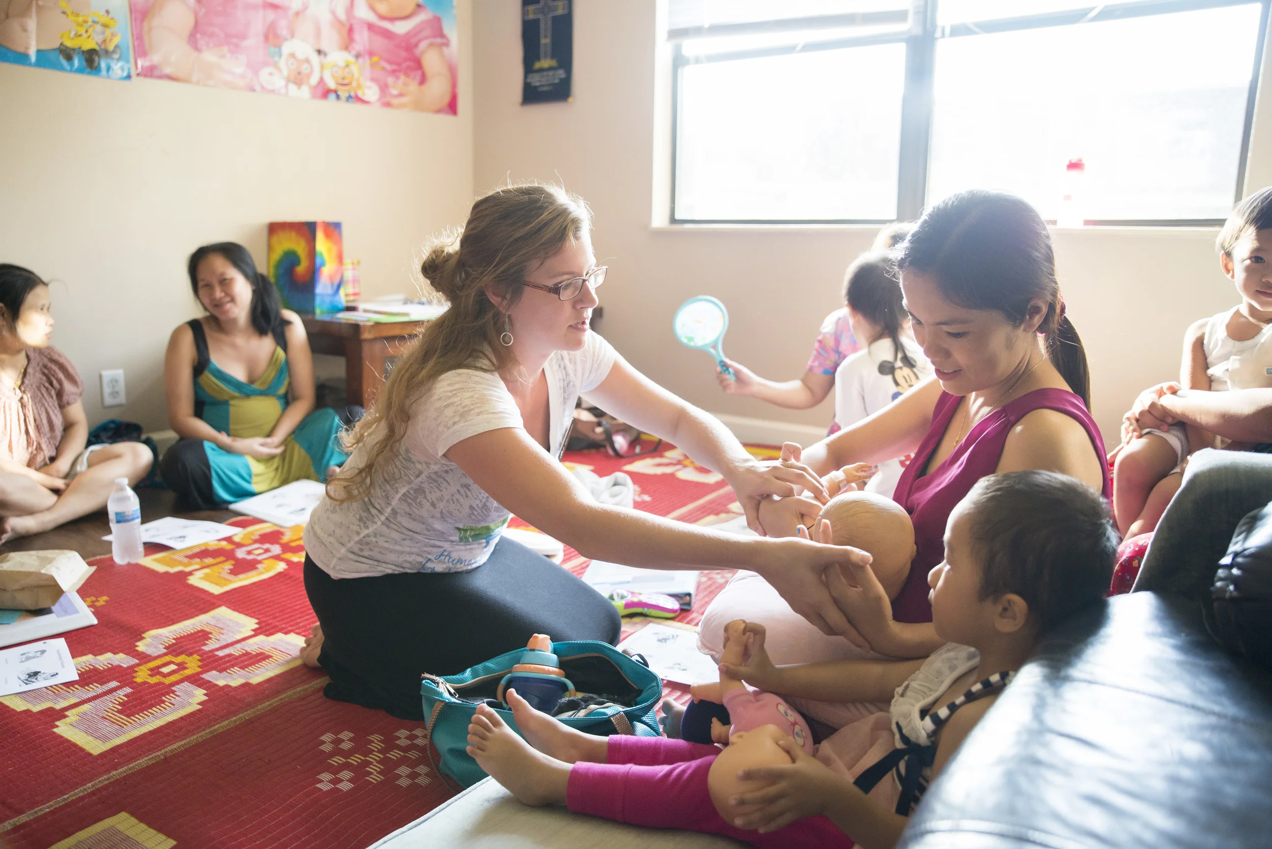 Julie Carpenter, LPN and Childbirth Educator, instructs a mother on a proper latch--one of the key components of breastfeeding, the key to nutrition in a baby's first years. 