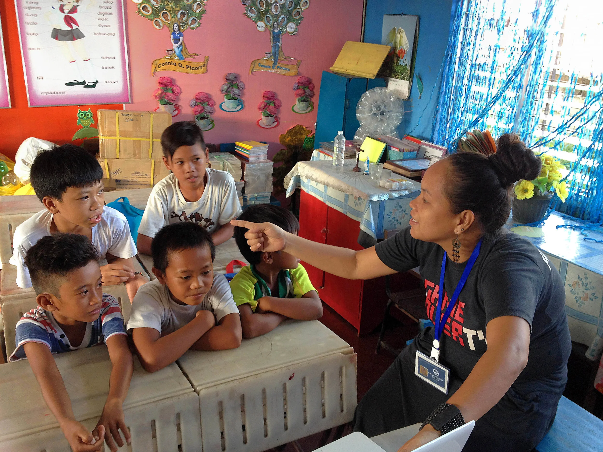 Rina Miller, cooperative and social worker, gives focused attention to a small group of students still struggling to read.