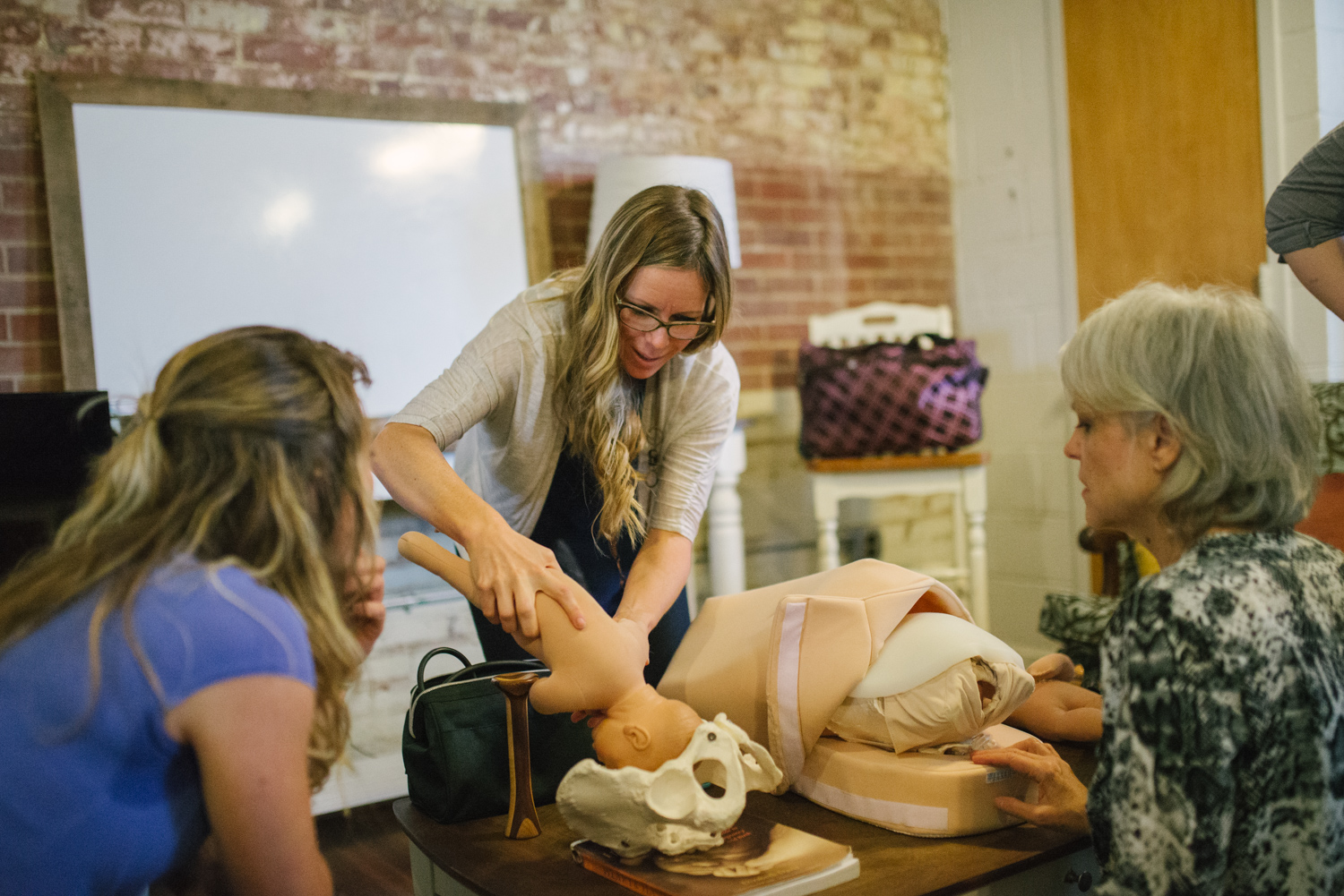 Tara Garner teaches students about the art of fetal palpation to help determine baby's position in the womb. The students practice on state-of-the-art birth models (in addition to real live pregnant mamas) as they are introduced to these valuable assessment skills.