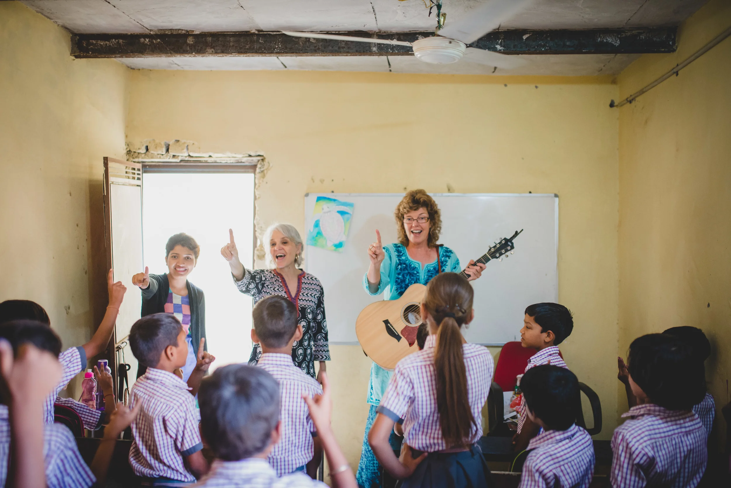 Linda Jobe (right) leads the kids in a song with Rosemary Sherrod, team facilitator, and Mahima, teacher at Aquatic Public School. Linda utilized skills she's gained over many years of leading worship and teaching children. The kids were delighted to learn new songs and motions and Linda was thankful to meet the students her daughter, Kelly, has been teaching for the past month.